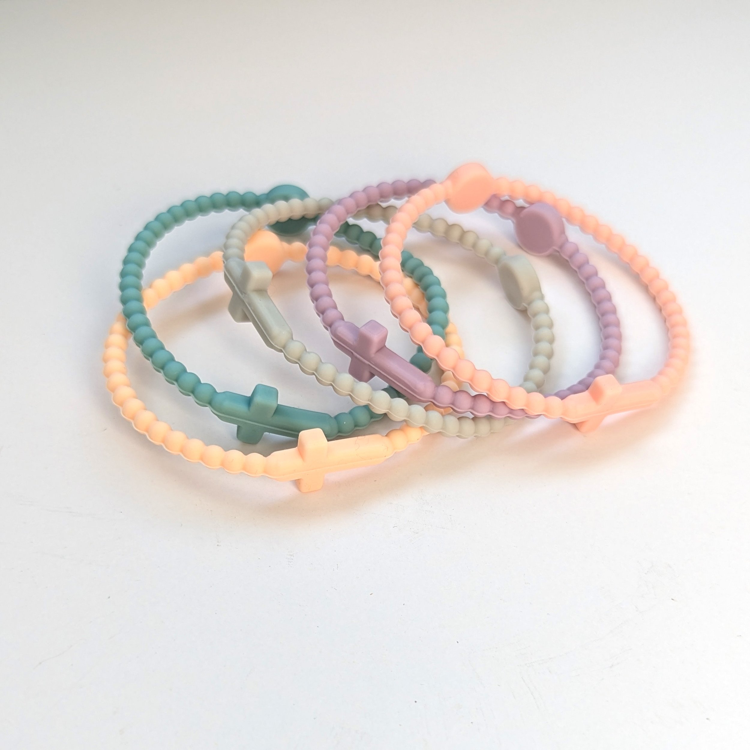 Faith silicone cross bracelets multicolor set of 5 shown in pastel. Set curated by Grace Notes Ltd.