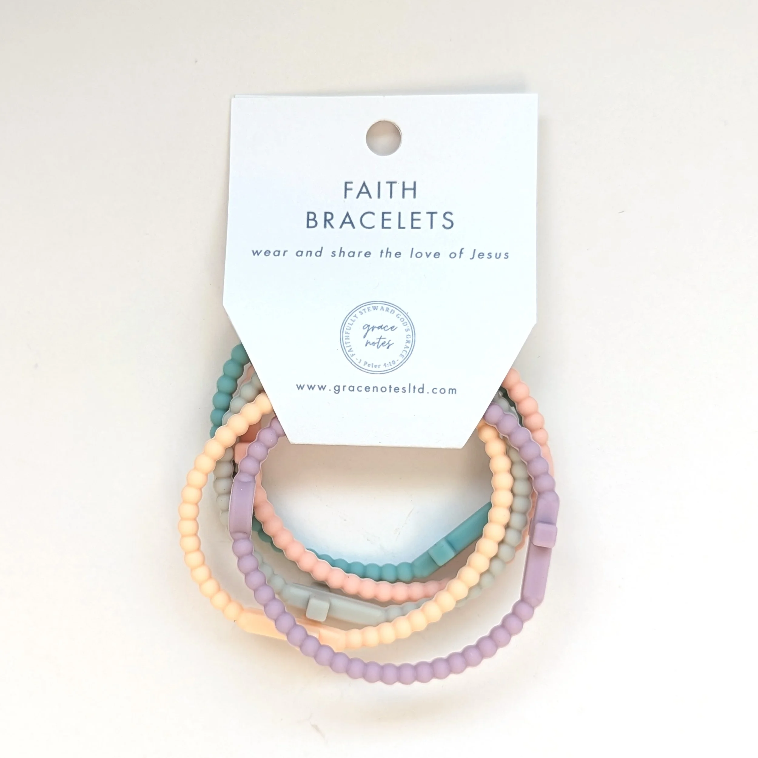 Faith silicone cross bracelets multicolor set of 5 shown packaged in pastel. Set curated by Grace Notes Ltd.