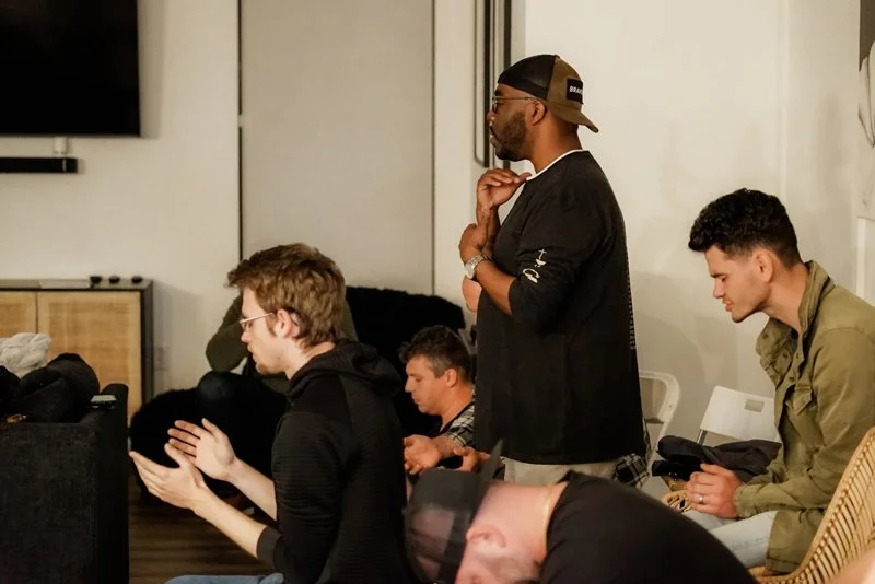 Men praying and worshiping during men's connect group