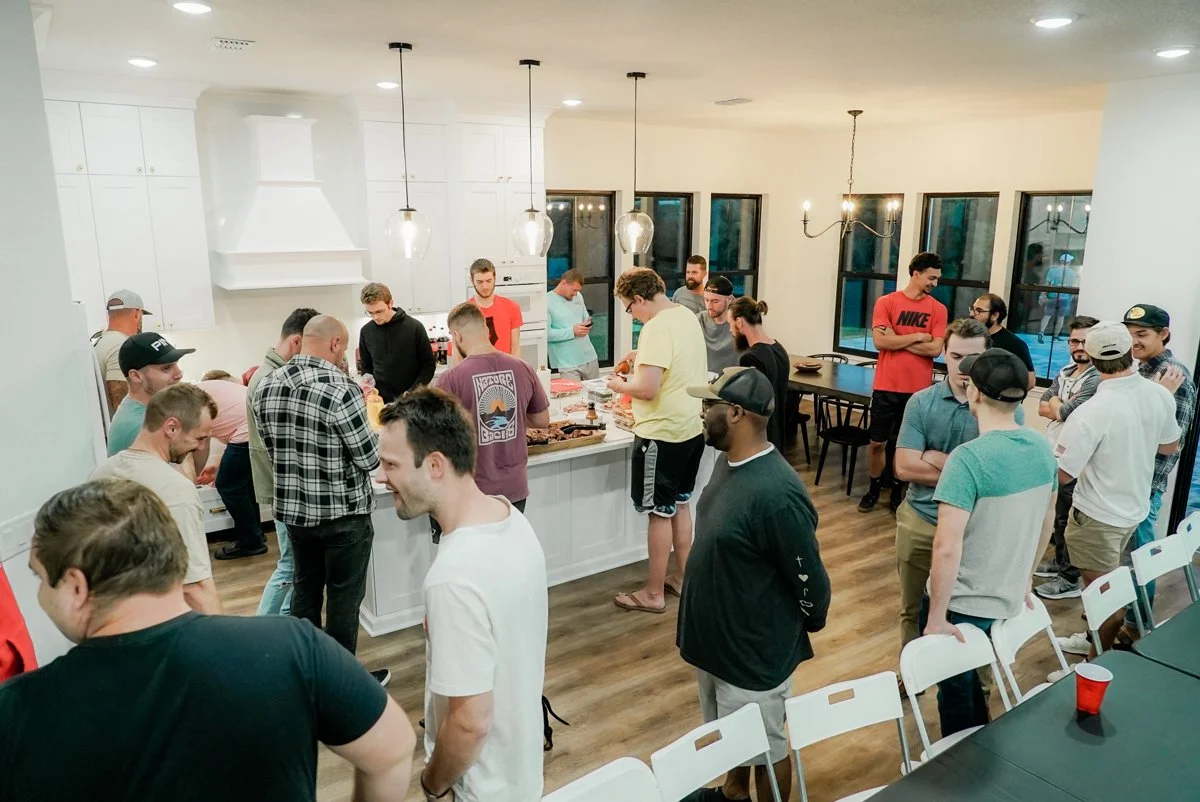 Everyone waiting in line for food at the men's connect group.