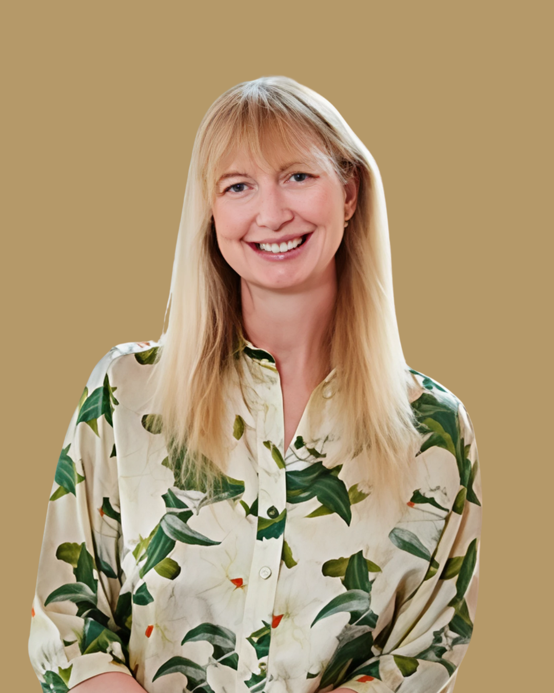 A blonde woman with long hair smiling, wearing a cream-colored shirt with a green leafy pattern, against a plain beige background.