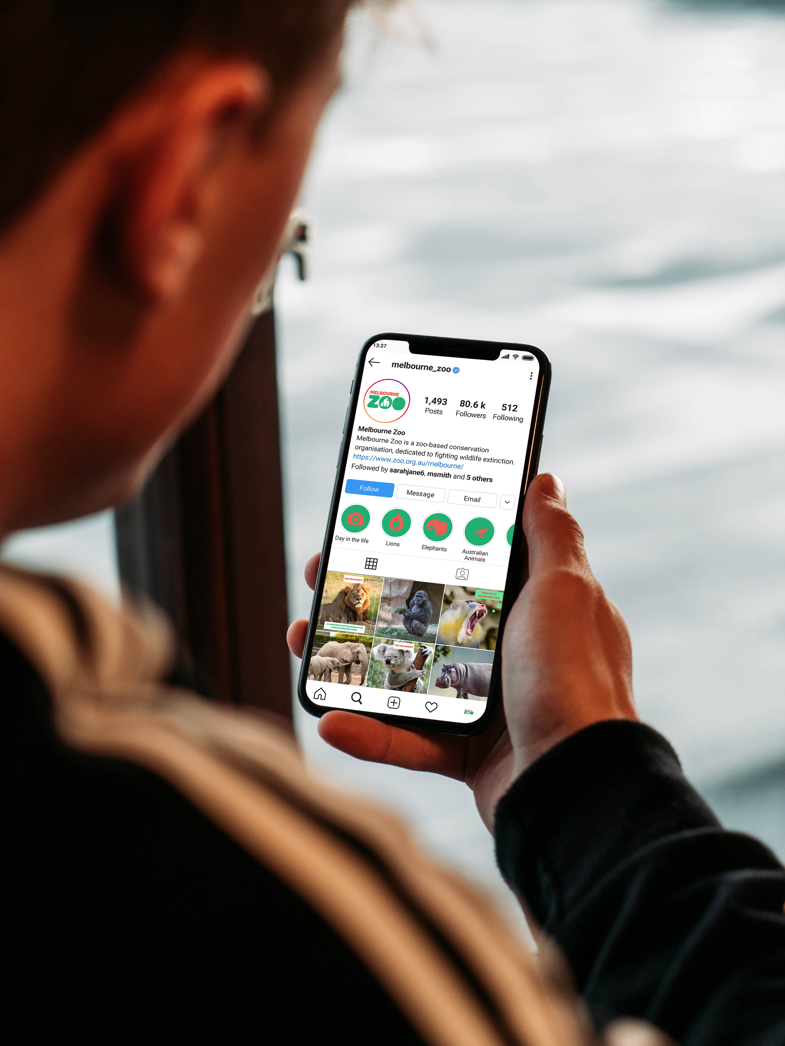 Man Holding iPhone Mockup.png