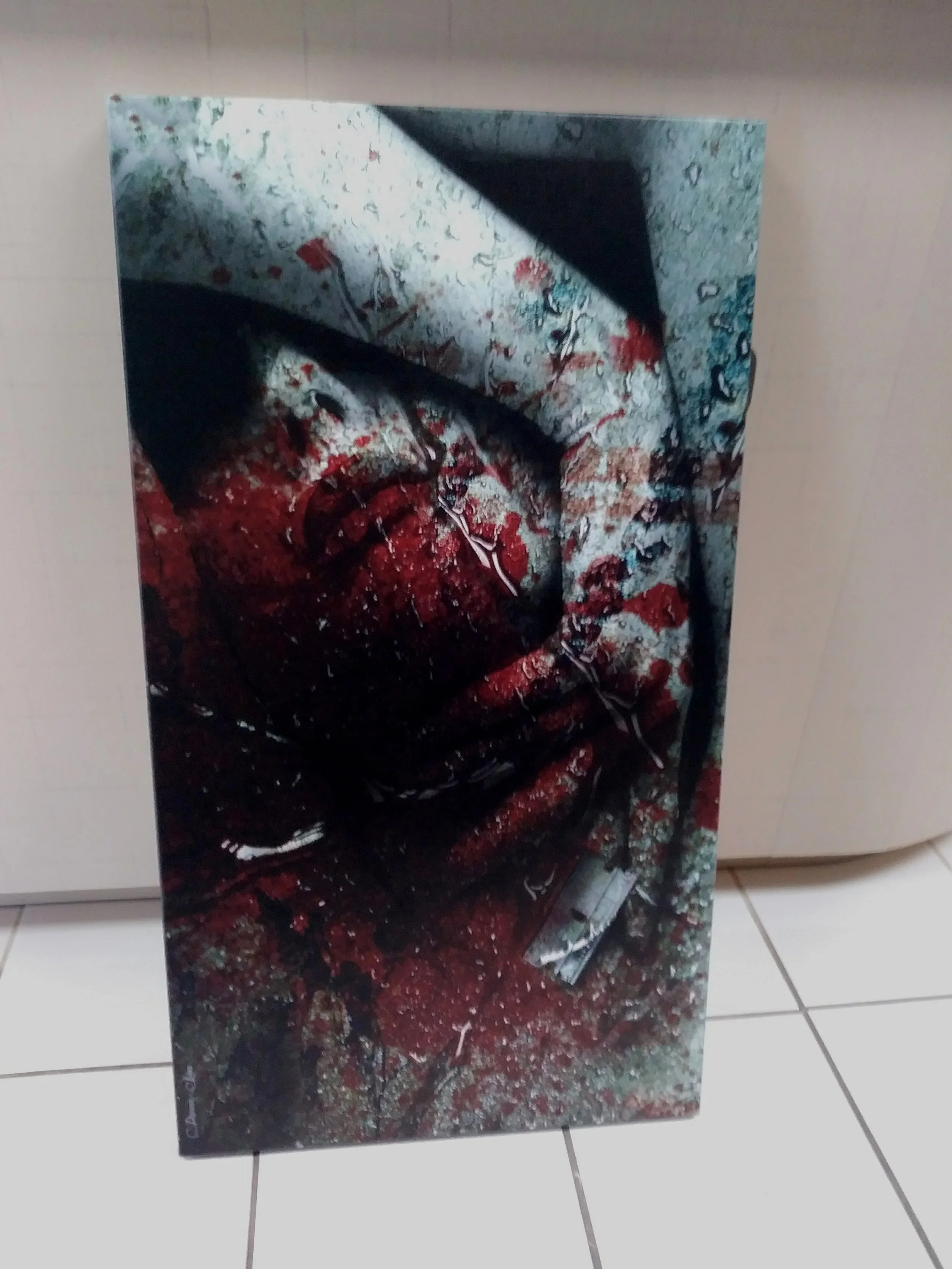 Abstract artwork with splashes of red, black, and white, featuring what appears to be a stylized face or mask with an eye and mouth, in a surreal style.