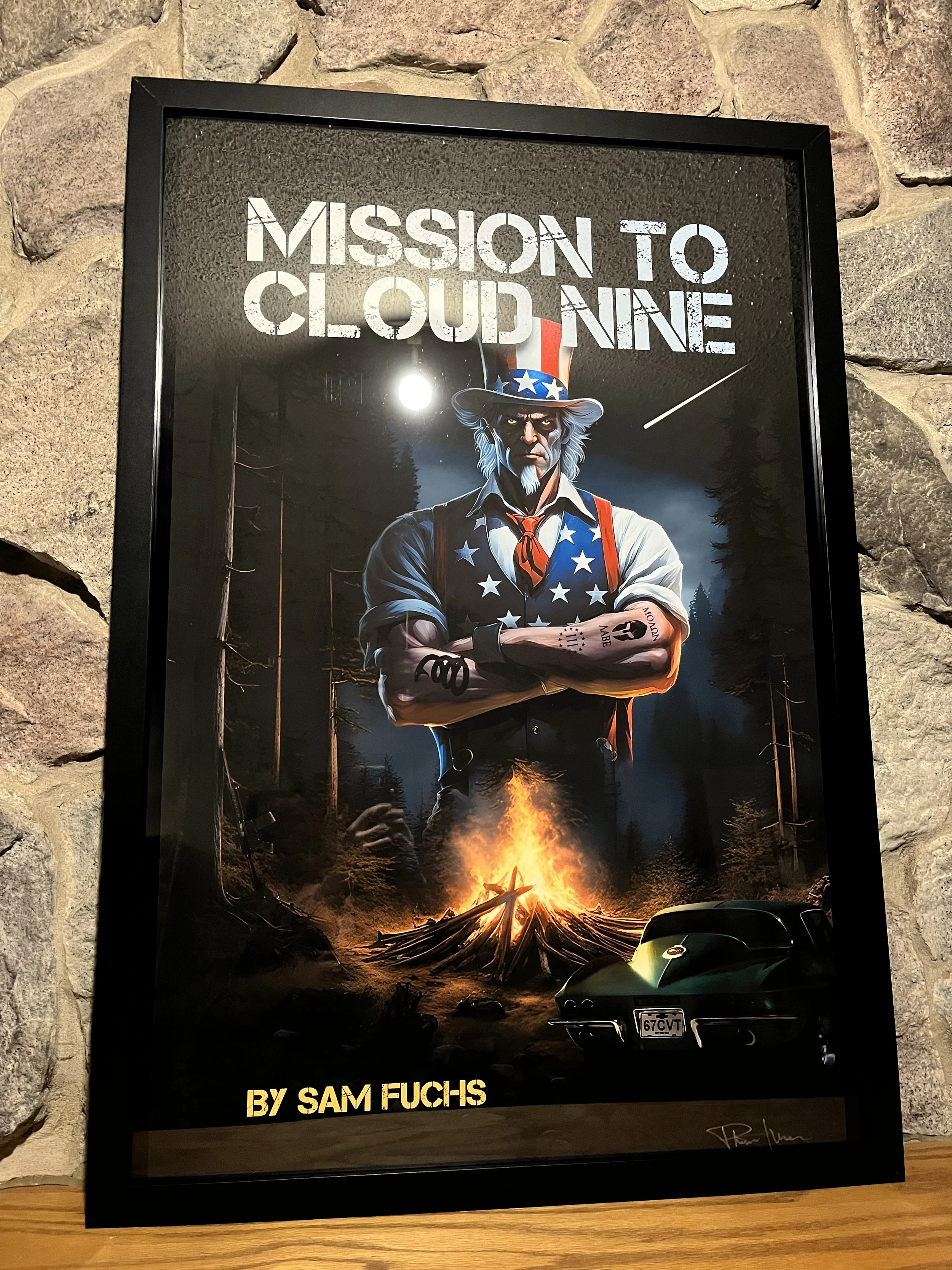 Framed poster of Uncle Sam with arms crossed, standing outdoors at night near a campfire, with a classic black car at the bottom. The poster is titled "Mission to Cloud Nine" by Sam Fuchs.
