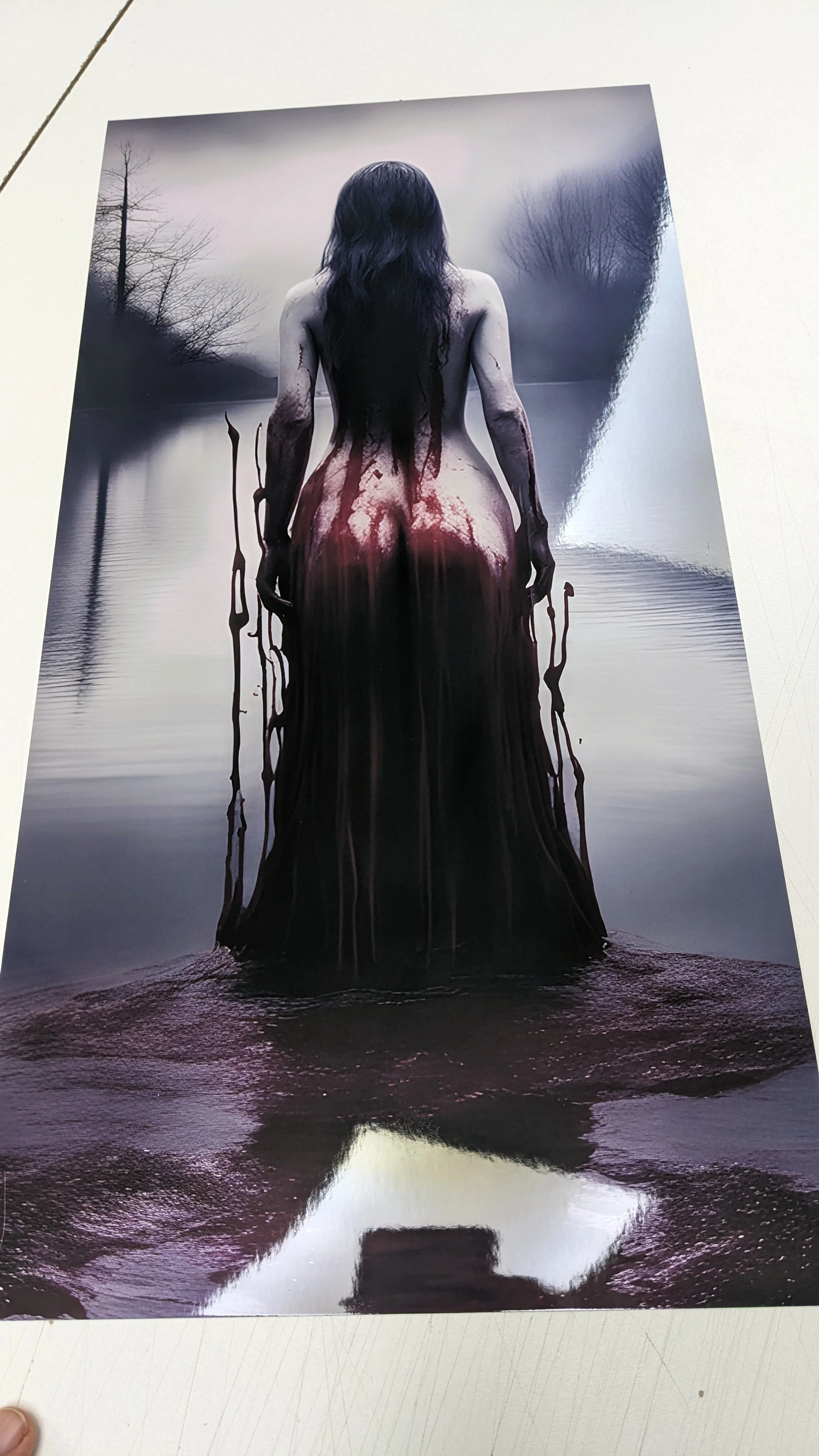 A digitally manipulated image of a woman with dark hair standing in water, her back turned, with her body appearing to flow into the water like dark ink or paint, with a gloomy landscape in the background.