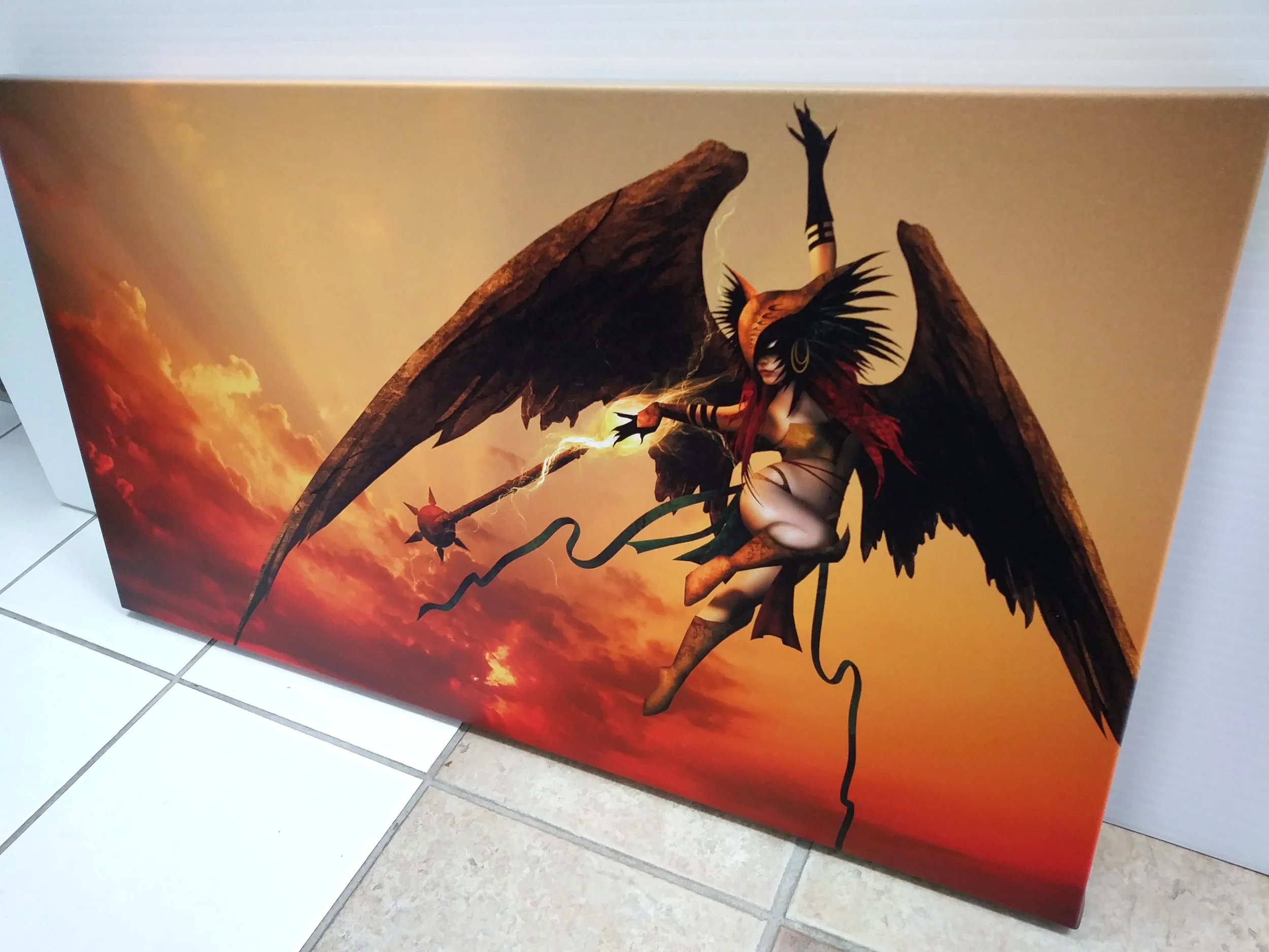 Artwork of a winged demon-like female figure with dark wings, wearing a red and black armor, holding a spear, against a sunset sky background.