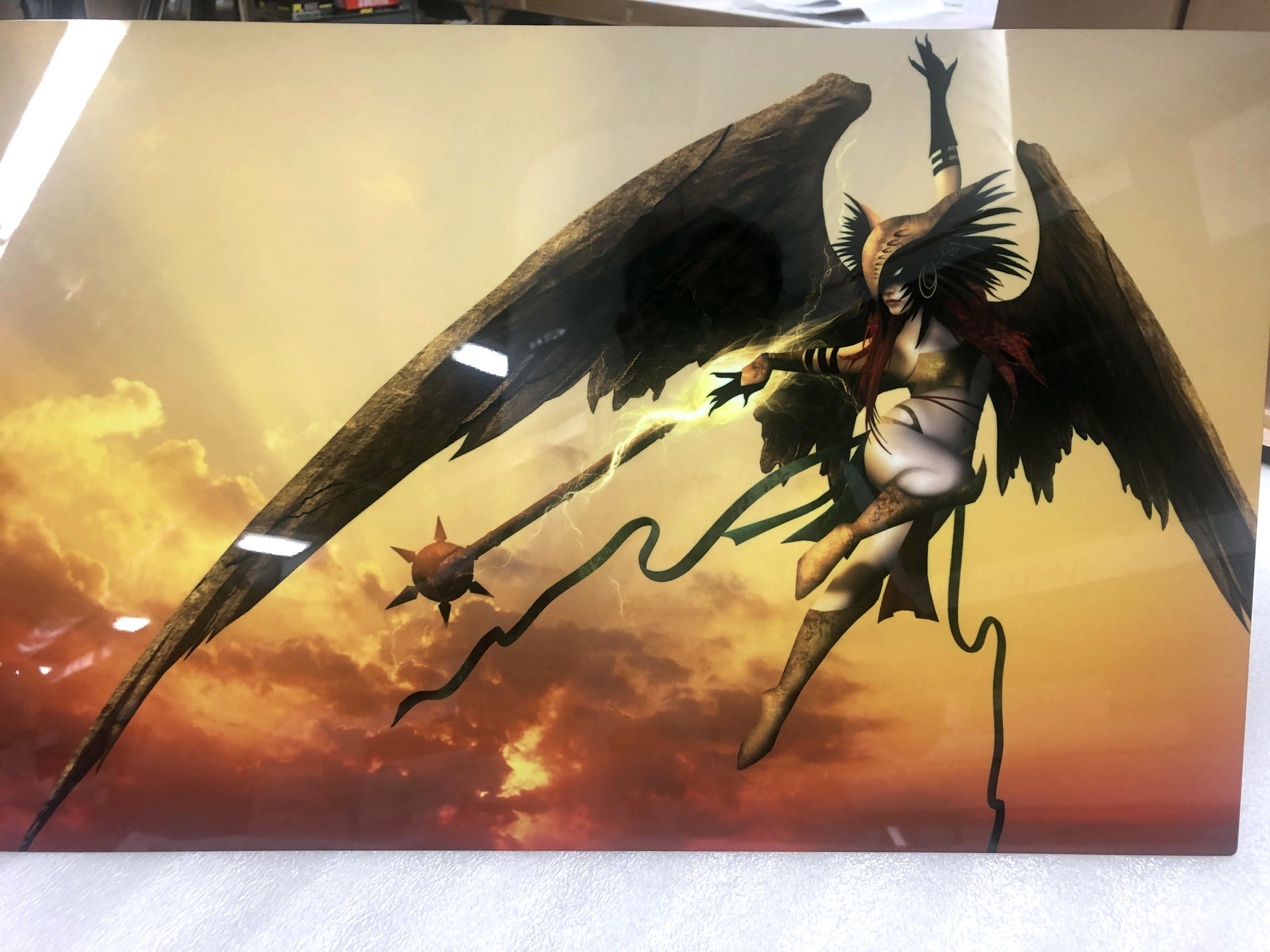 A fantasy illustration of a winged female warrior with a horned helmet and armor, holding a spiked mace, flying against a dramatic cloudy sunset sky.