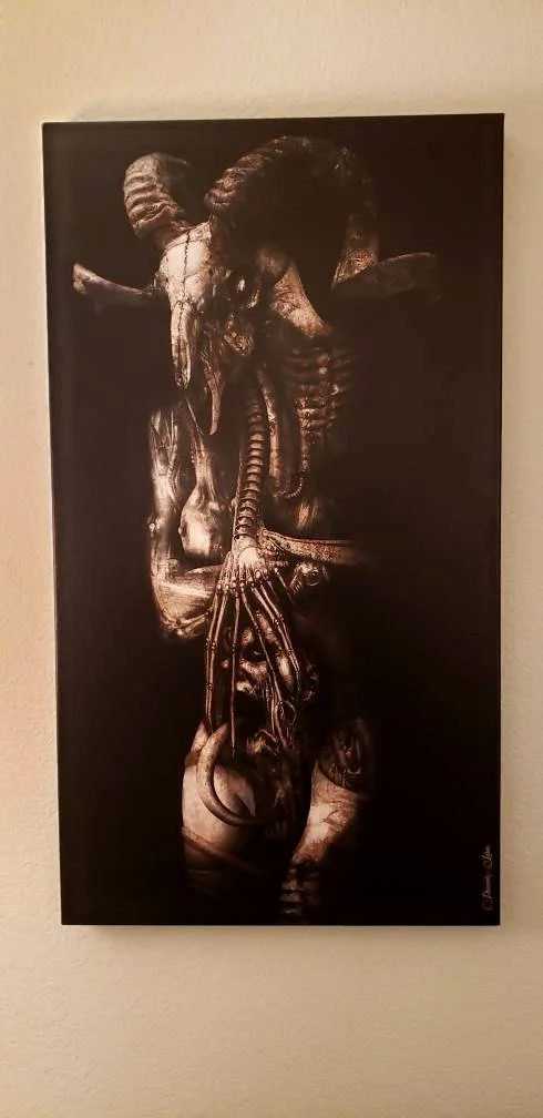 Sepia-toned artwork of an abstract humanoid figure with animal skulls, horns, and mechanical elements, standing against a black background.