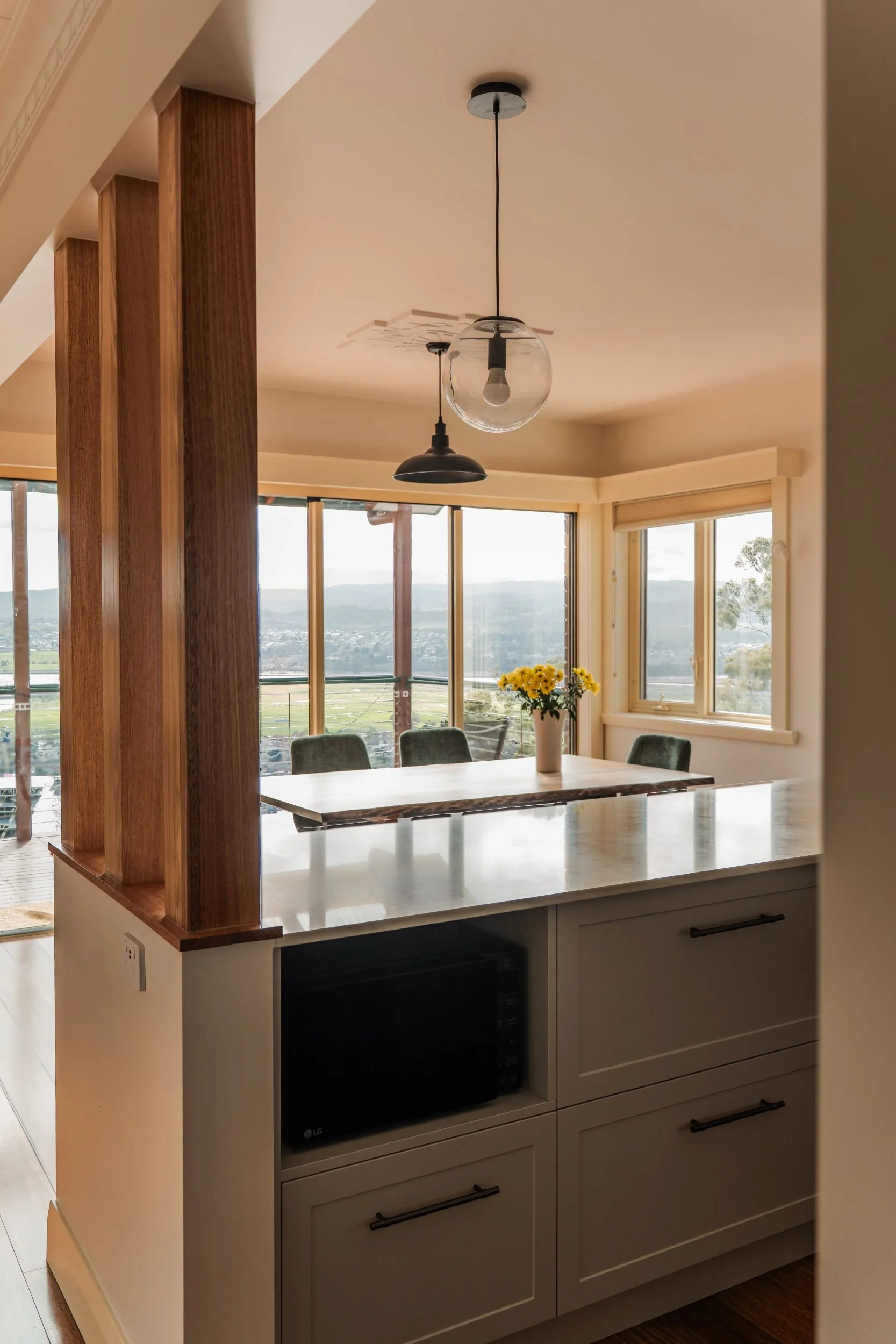 View through timber posts to the dining table and river view