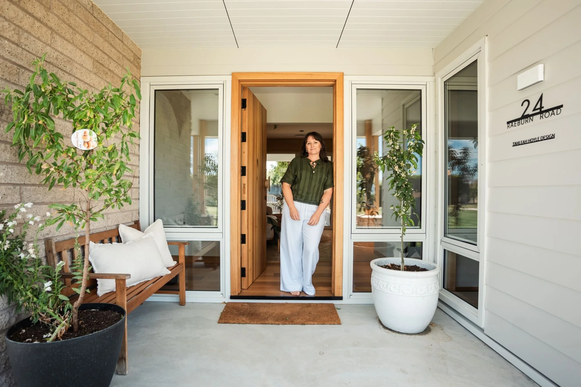 Designer Tahleah Hoyle standing at the entry of her Raeburn residence and studio in Breadalbane, Tasmania.