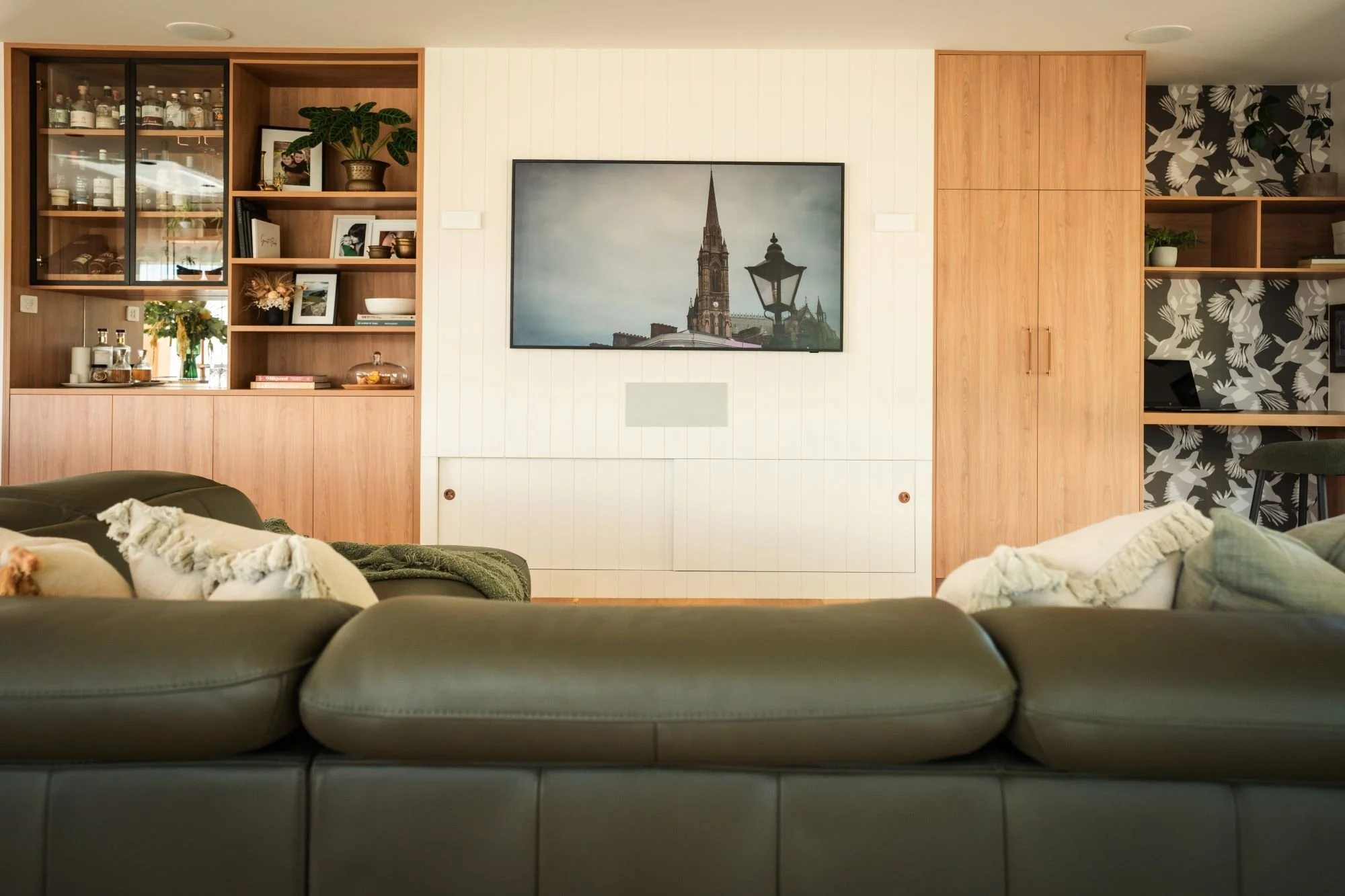 Built-in storage and display shelving integrated into the Raeburn living room joinery.