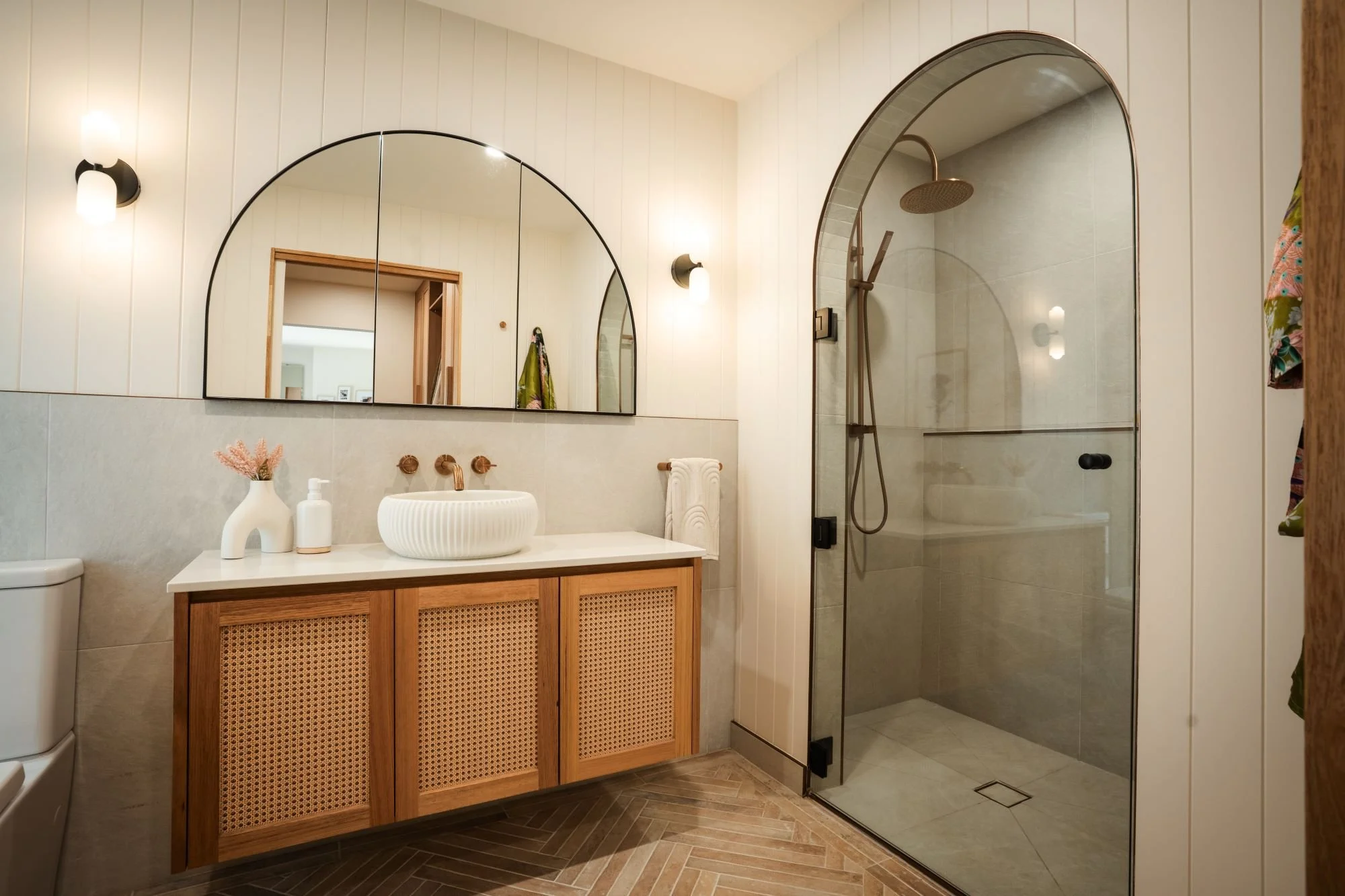 Ensuite bathroom at Raeburn featuring arched shower and custom vanity.