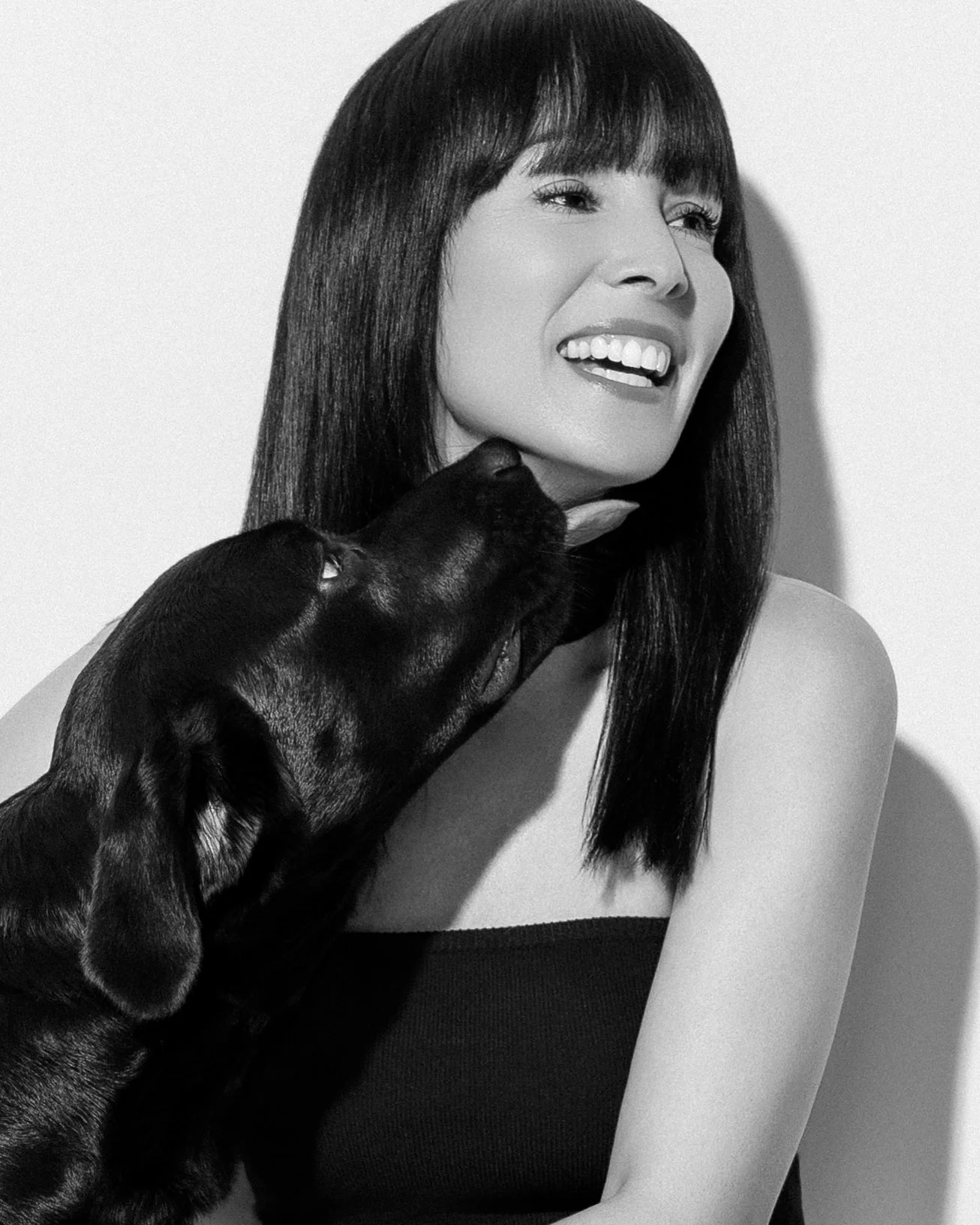 Close-up portrait of a Siberian Husky with heterochromatic eyes, one blue and one brown, against a dark background.