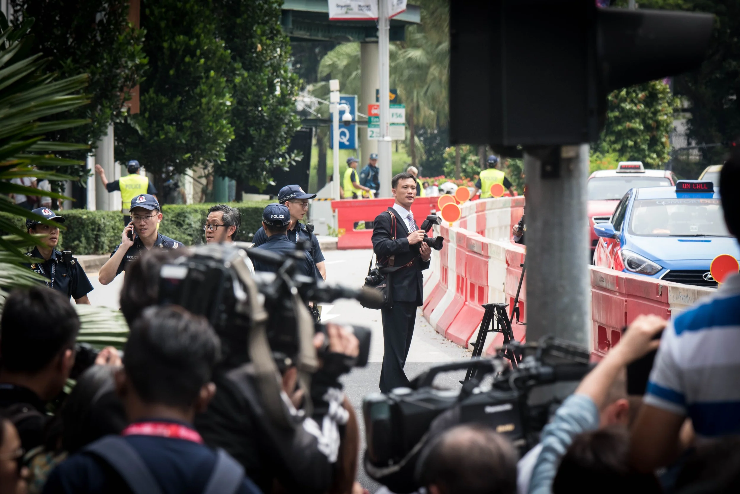 As the arrival of North Korean supreme leader Kim Jong-un looms imminent, the Singapore Police Force ramps up security for the North Korean media official who gets into his position outside the vicinity of St. Regis hotel for the 2018 North Korea–Uni
