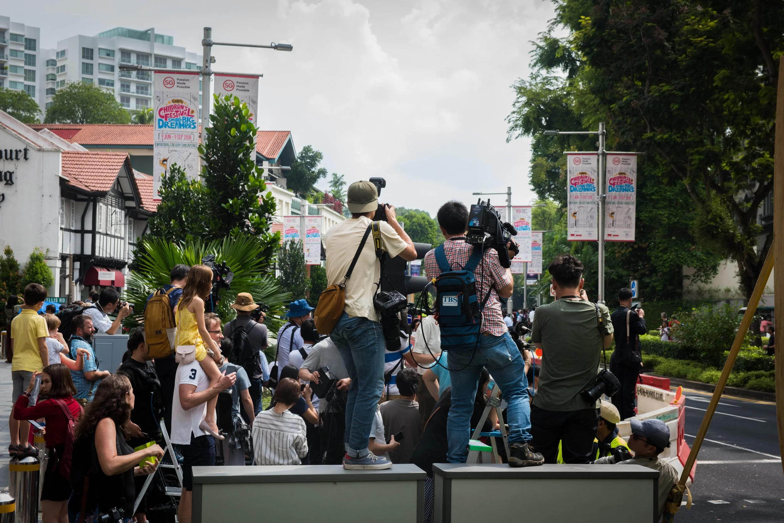 As word of Kim Jong-un's entourage approaching the hotel reaches the journalists, they flock to the main road to get a glimpse of his entourage outside St. Regis hotel on 10 June, 2018.