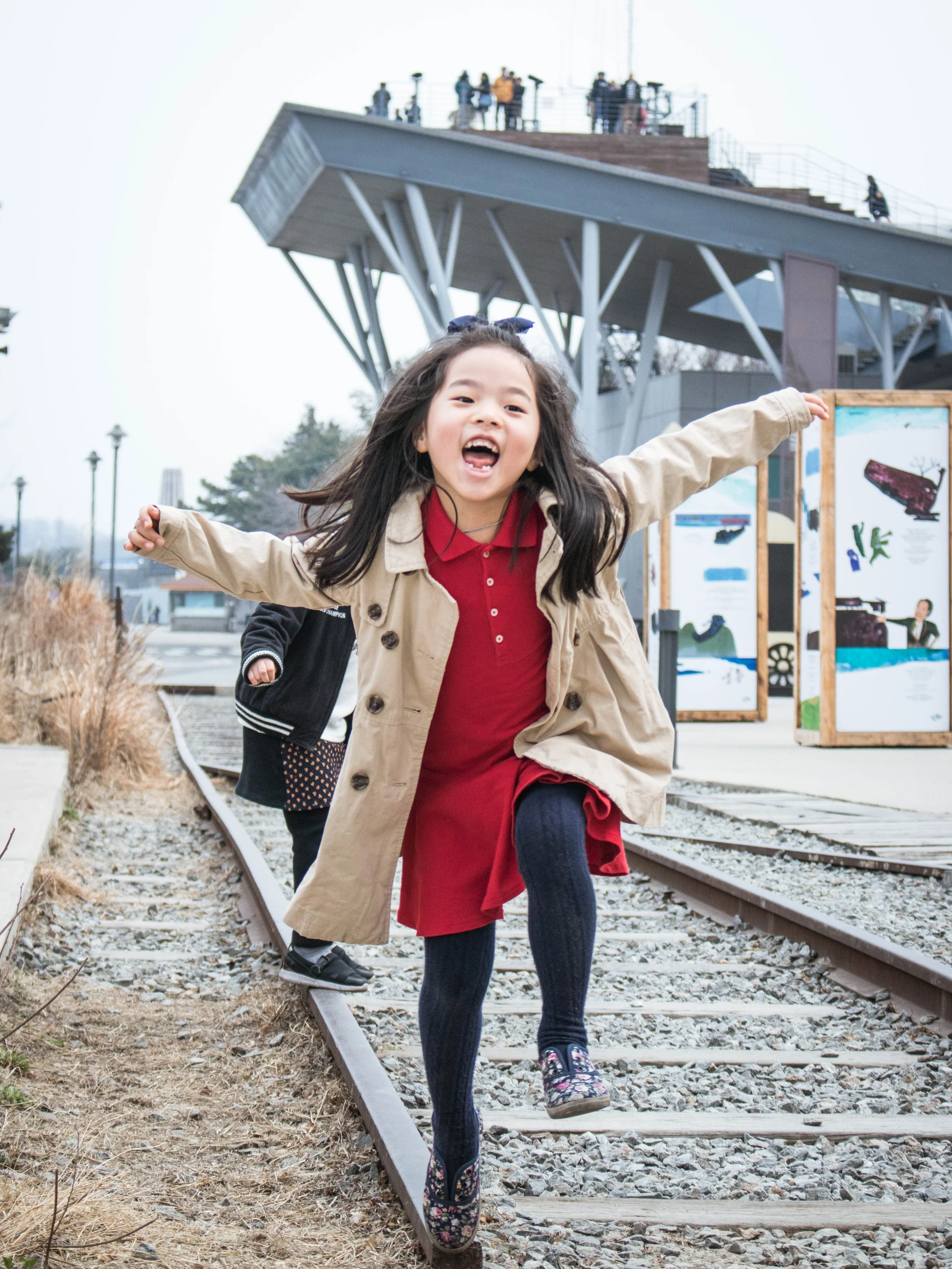 A child balances her way on an abandoned railway that once operated between the northern and southern halves of Korea before the division in 1945. It was known as the Gyeongui Train Line.