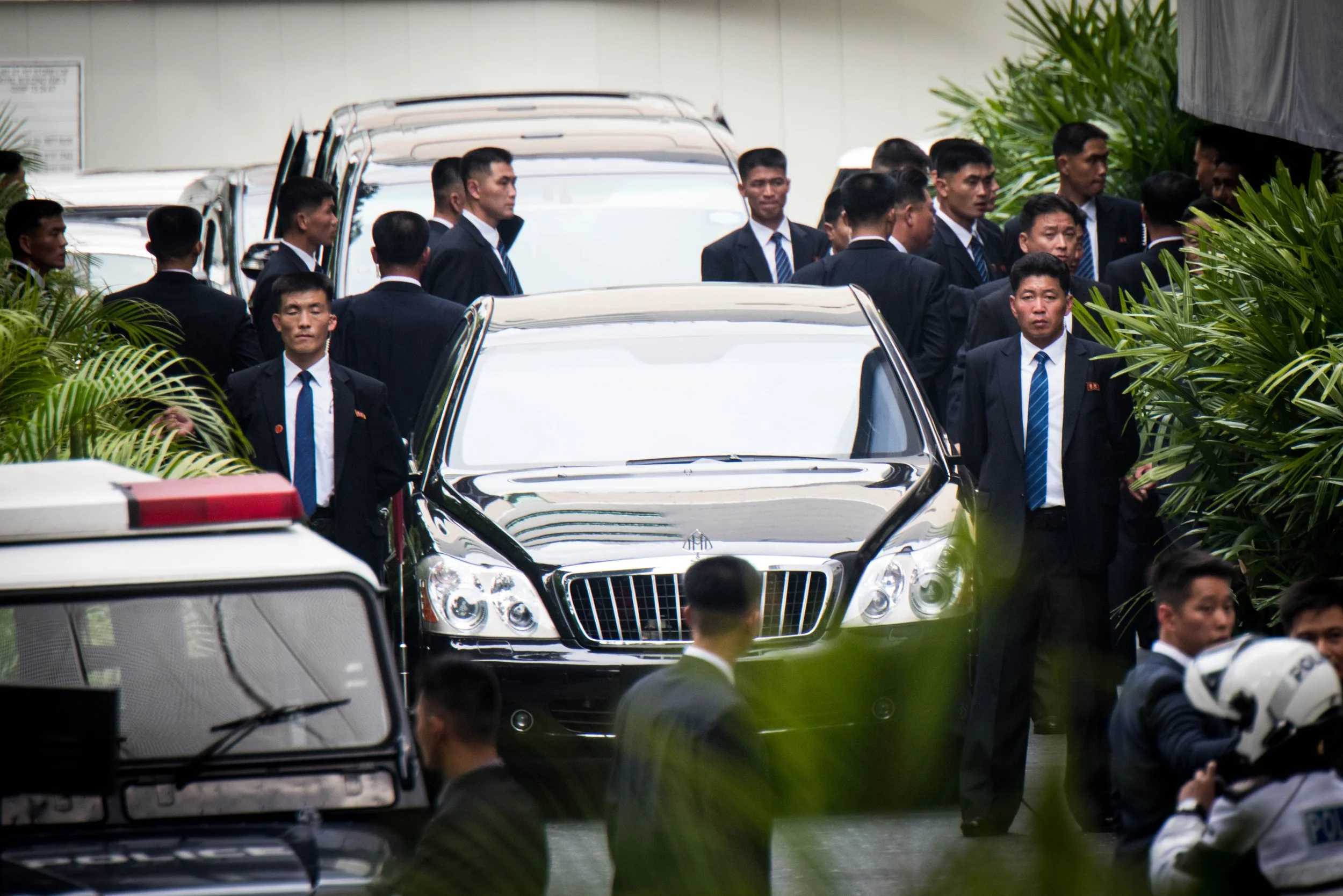 There was a tight entourage around Kim Jong-un's arrival at the St. Regis hotel designated drop-off point as they had to ensure the path was secure before he could leave the vehicle on 10 June, 2018.