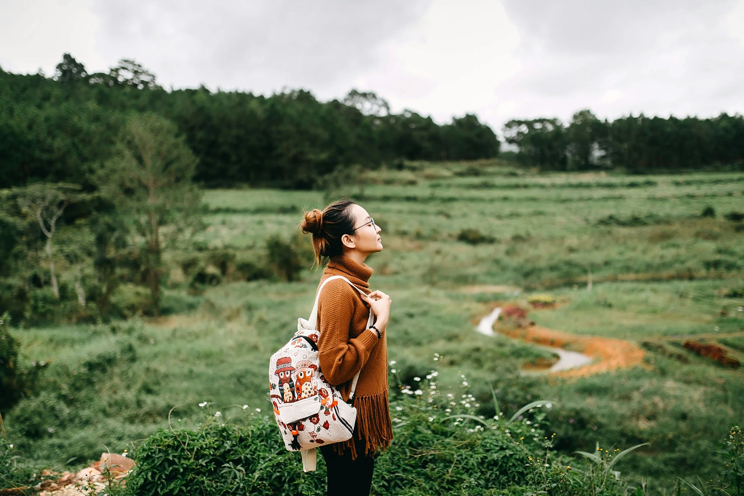 girl in green woodland taking in nature