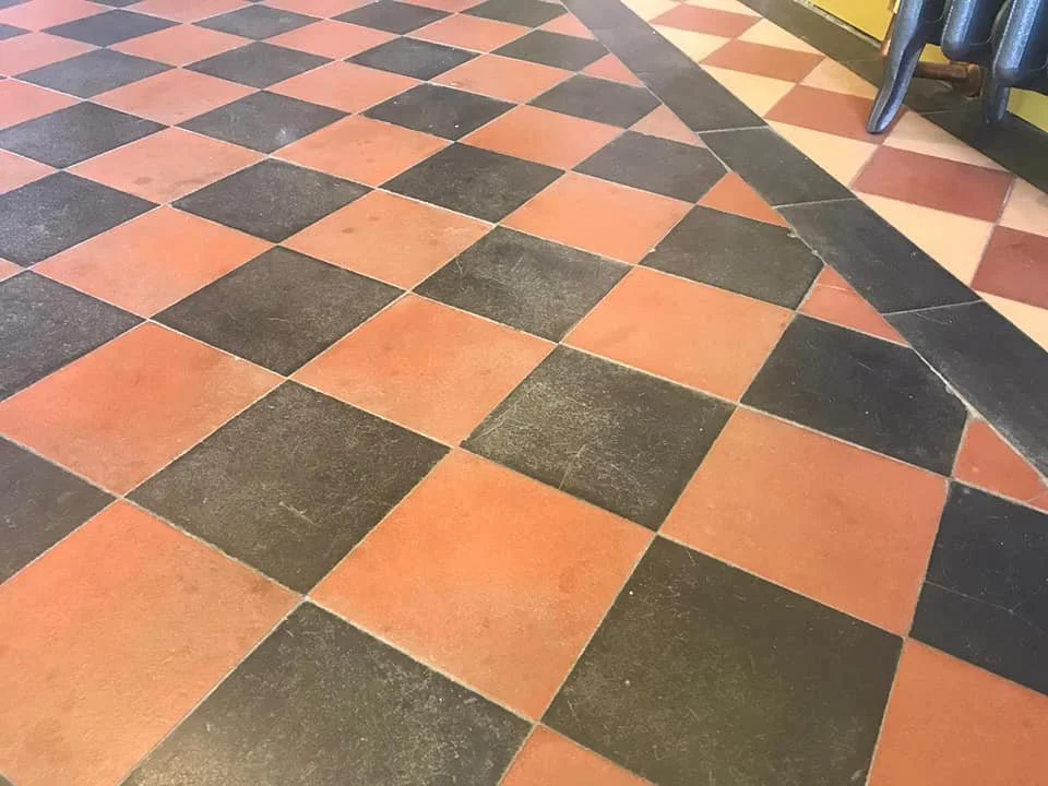 Checkerboard floor with red and black tiles