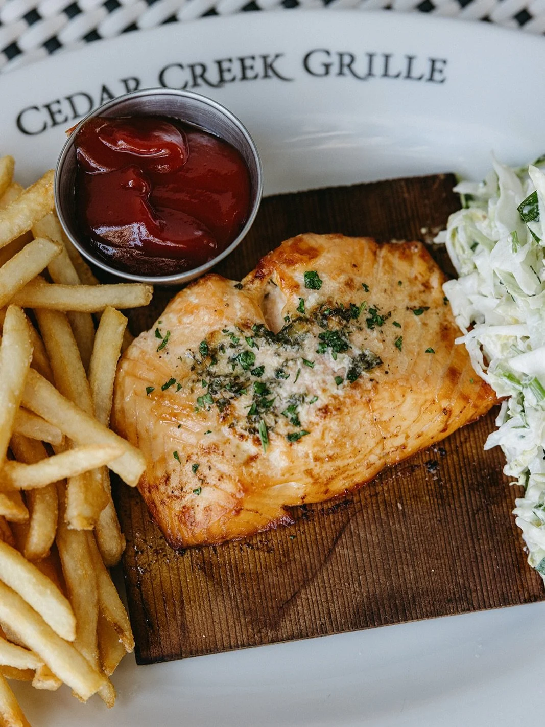 A grille favorite. 

Cedar Plank Roasted Atlantic Salmon
filleted in-house daily, lemon butter, house-made coleslaw, french fries