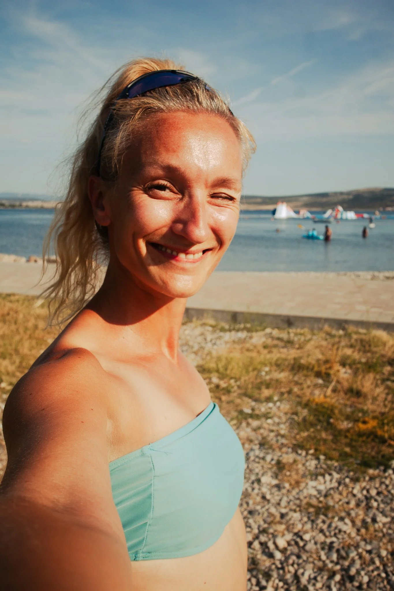 Woman smiling at the camera with a sea background