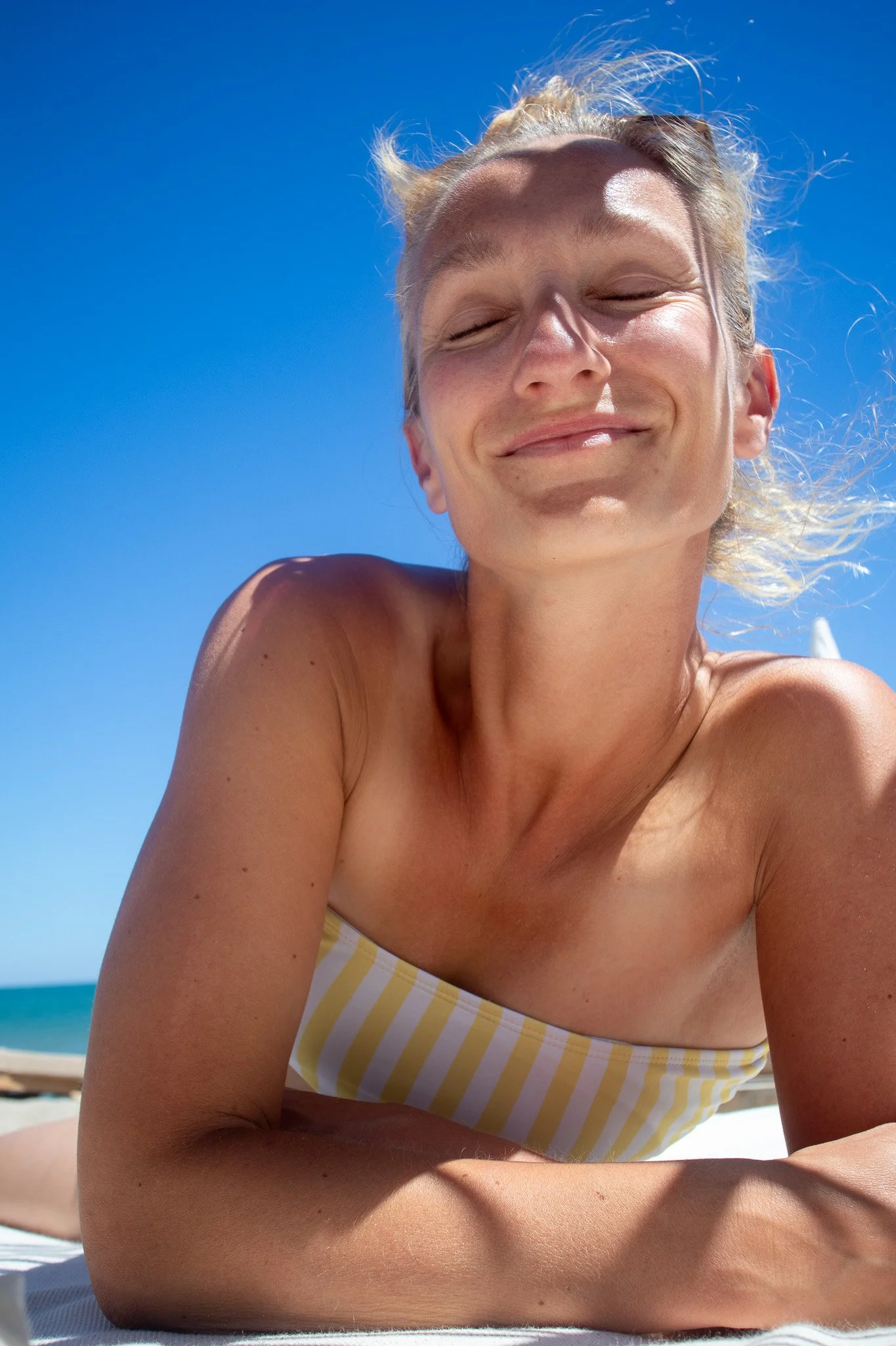 Woman relaxing in the sun smiling