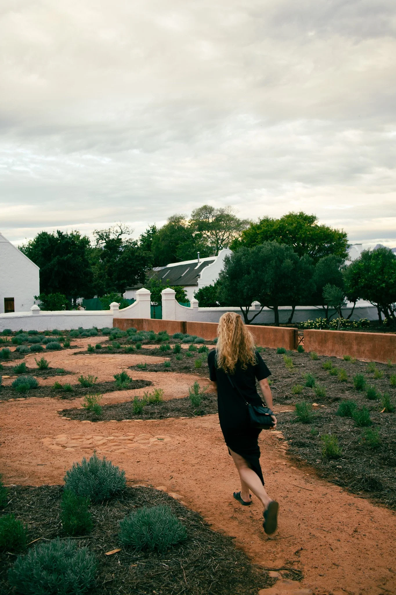 Woman stressing and running in Babylonstoren