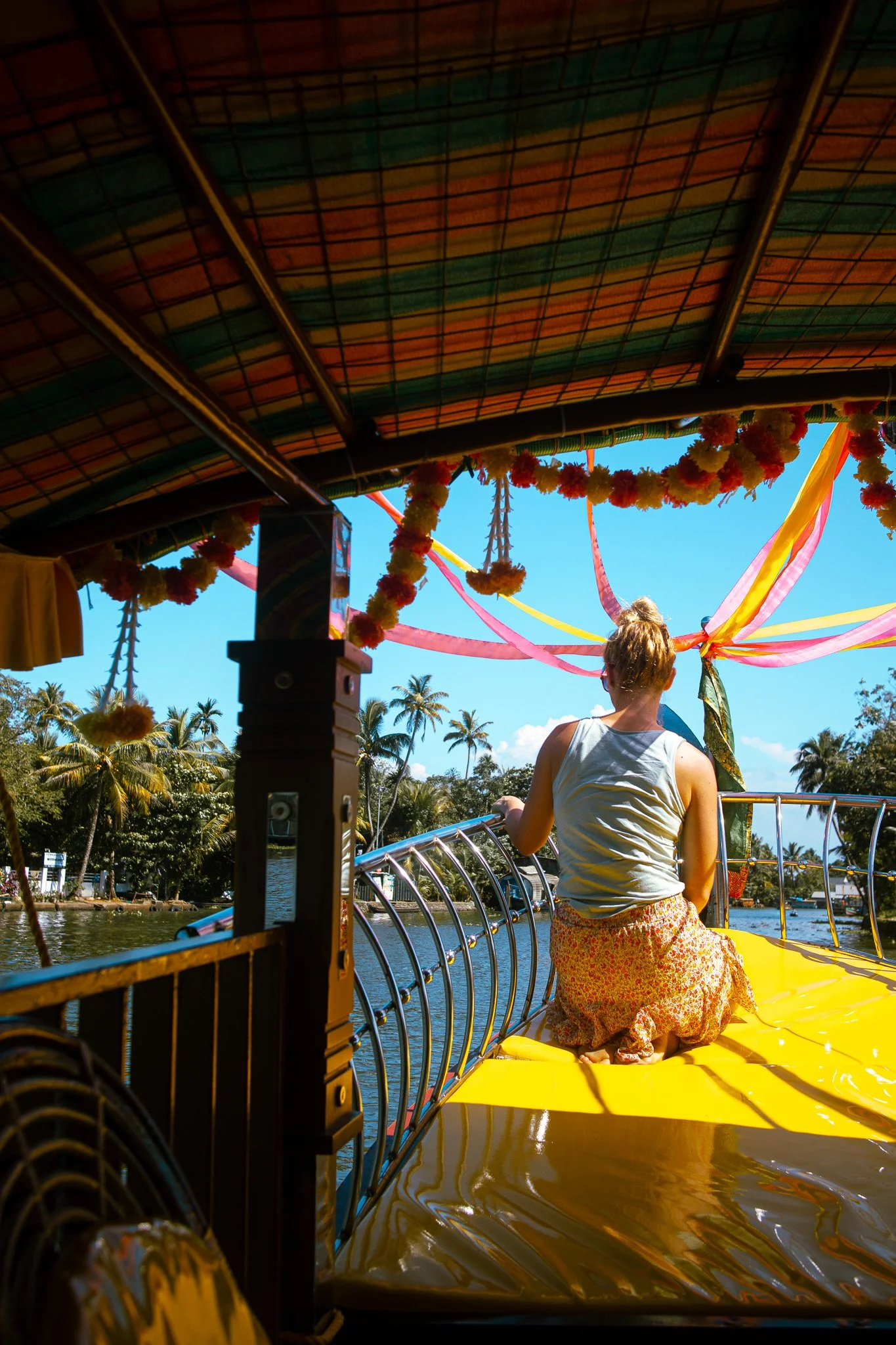 Woman on colorful boat in Alleppey, India