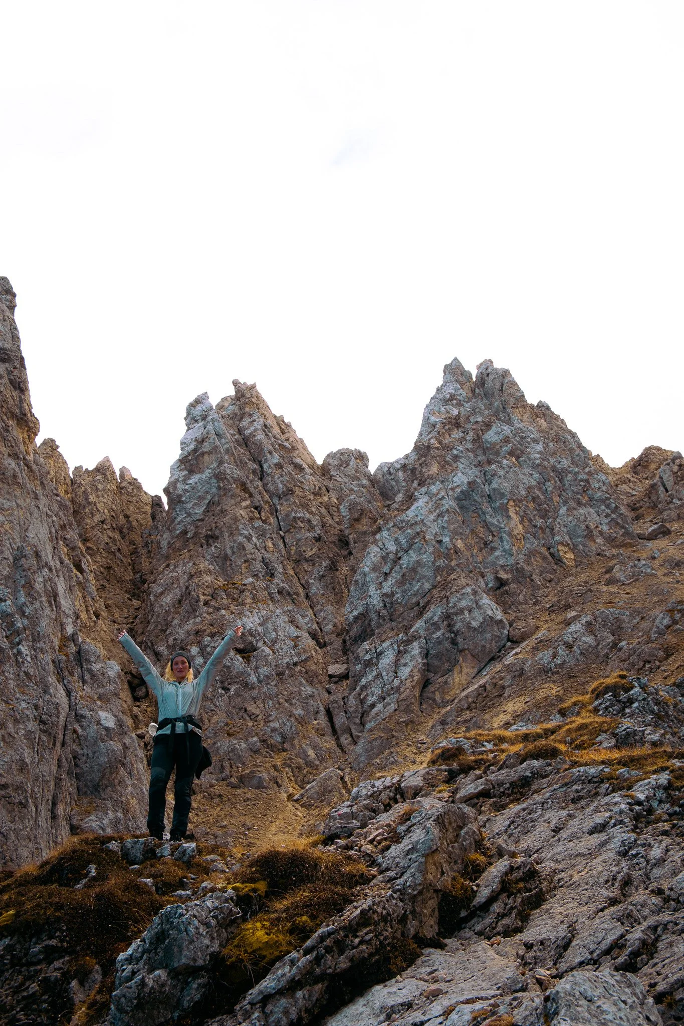 Woman hiking on top of The Dolomites feeling free