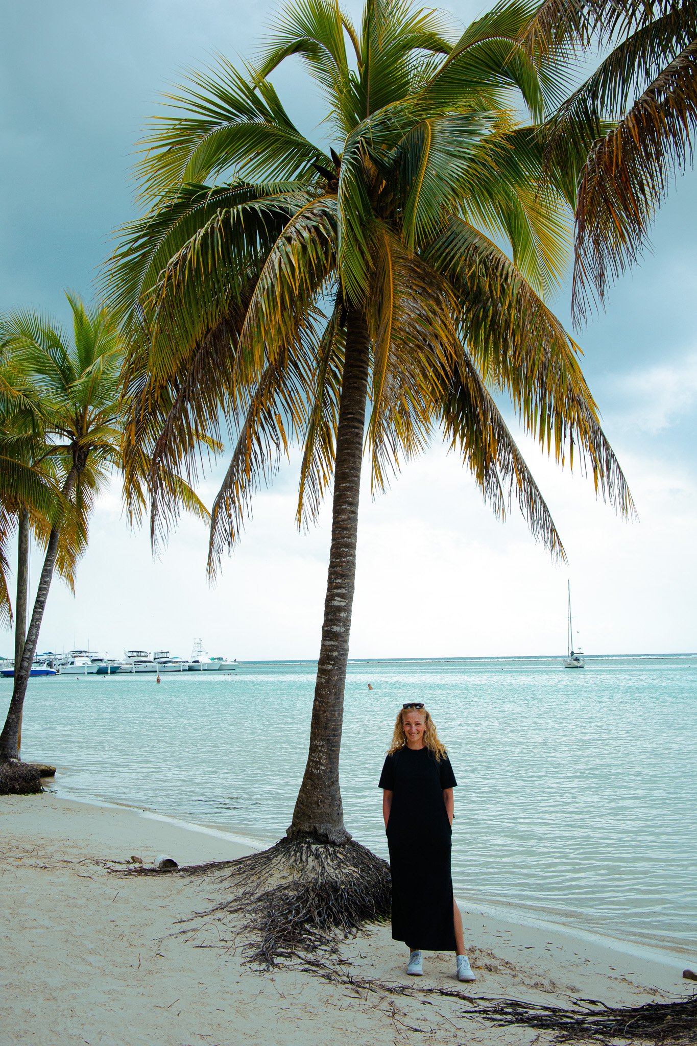 Woman standing in front of big palm trees