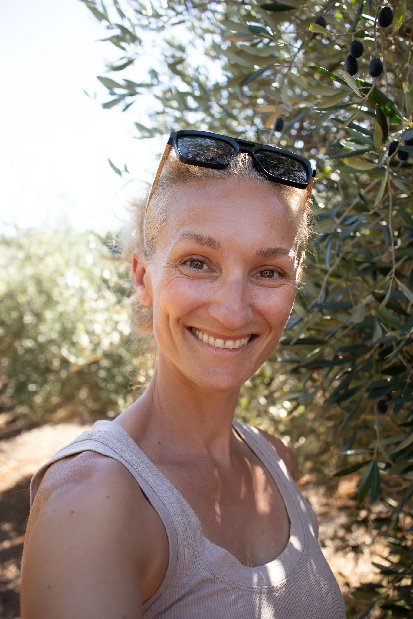 Woman smiling in an olive field