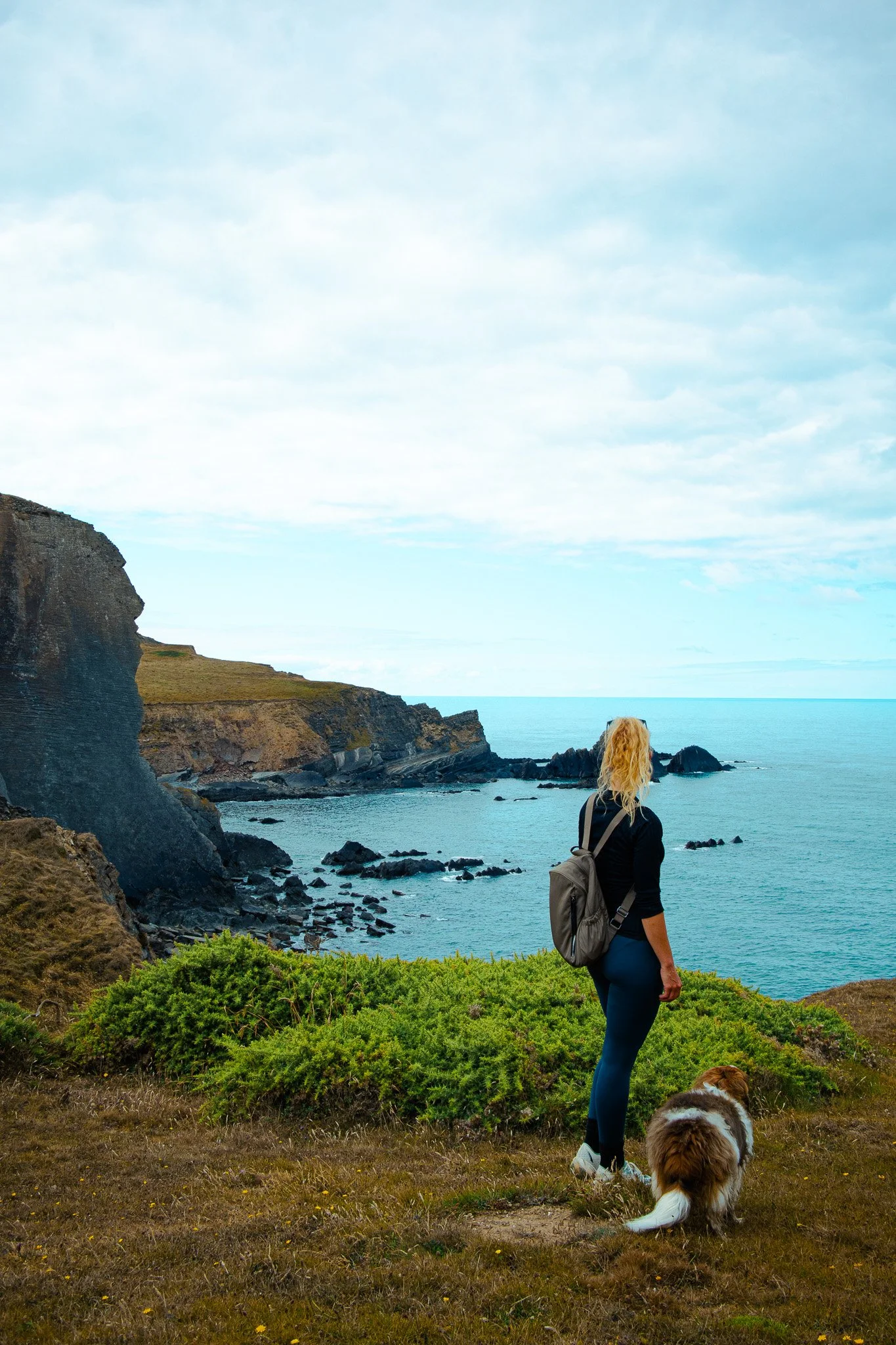 Woman with her dog on a coastal hike