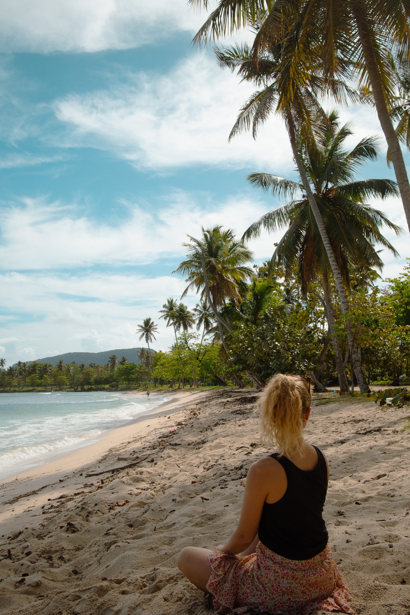 Woman sitting on a tropical beach