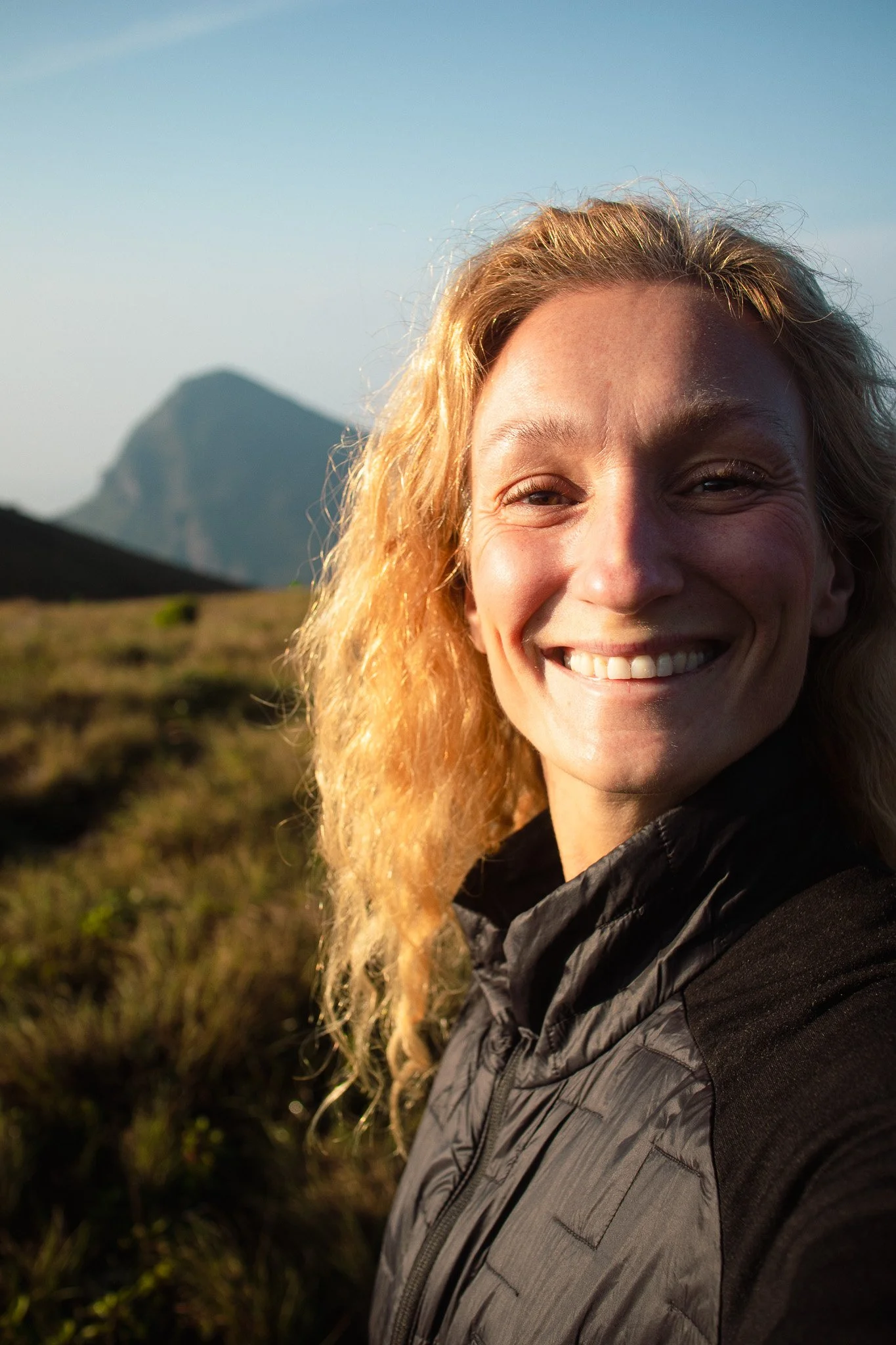 Smiling woman on top of a mountain
