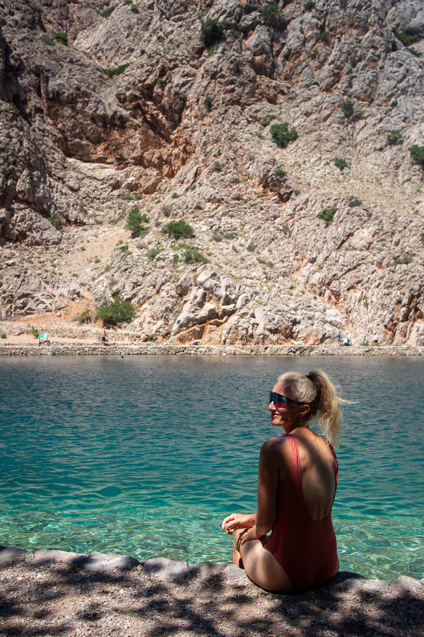 Woman sitting and relaxing by the clear sea