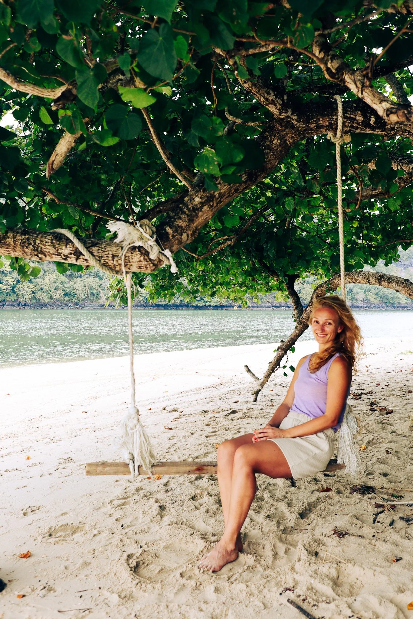 Woman sitting on a swing in Thailand