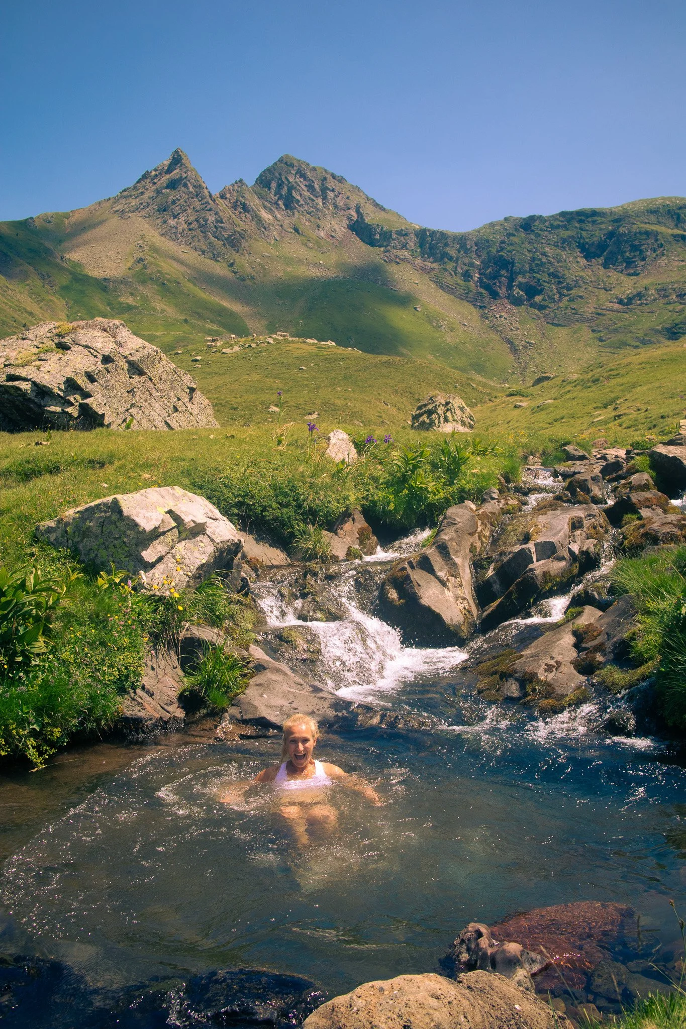 Woman swimming in a mountain lake in Italy
