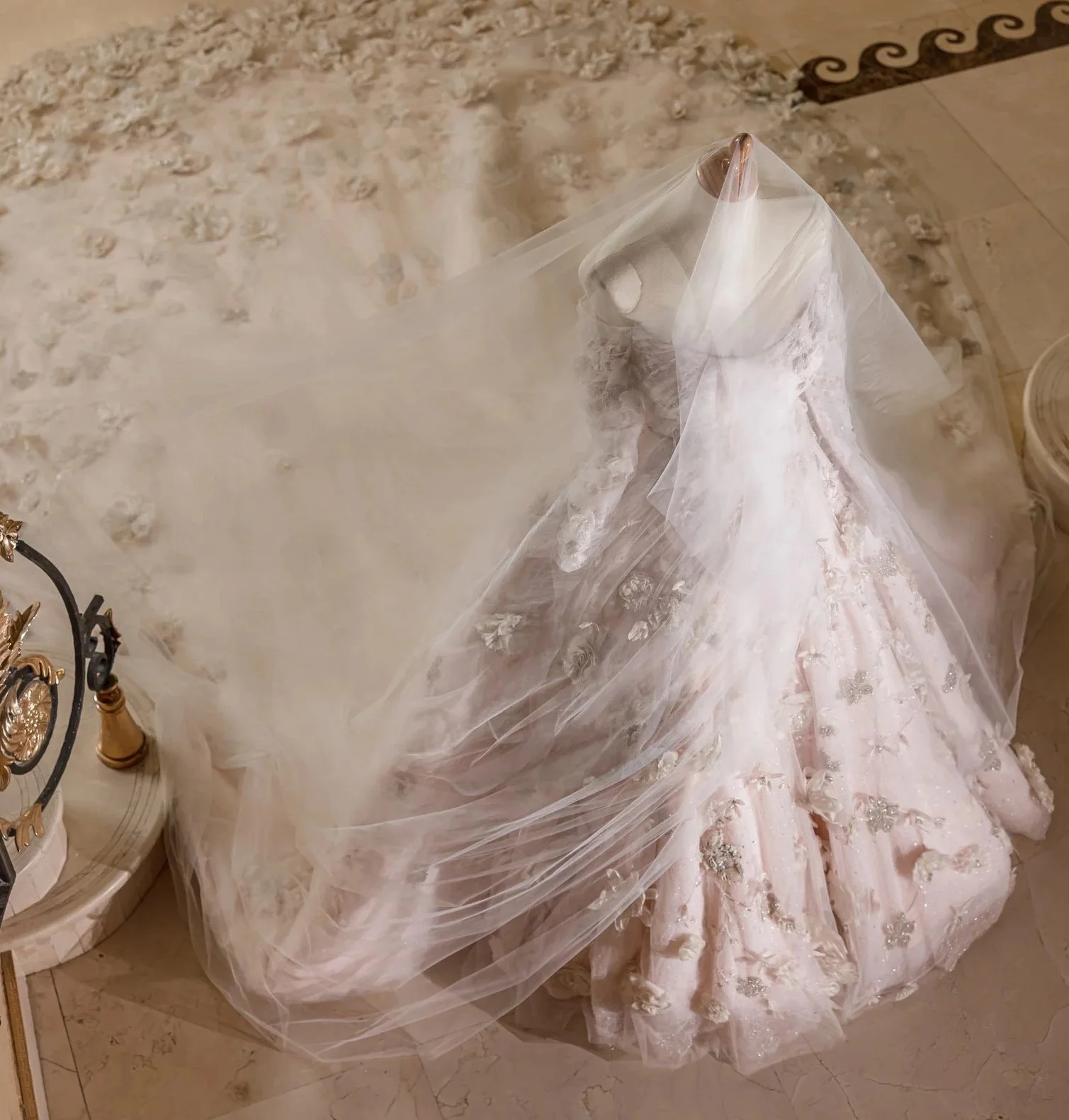 Bridal couture gown on a manniquin. The gown has custom hand made flowers and it was styled by Luxury bridal styling couture with Christina