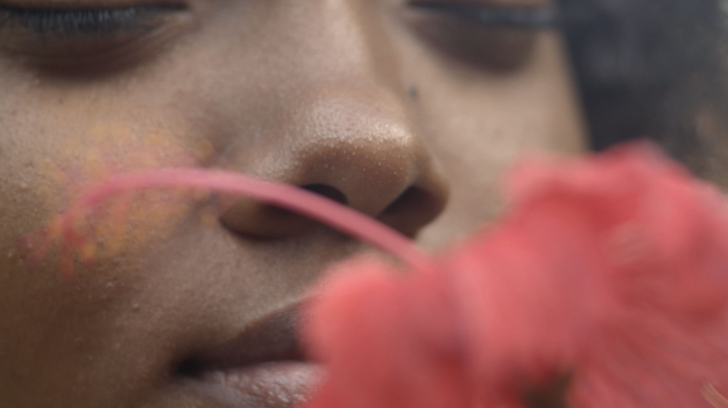 Jaydee's Naturals Ad Still - One Off - Smelling hibiscus.png