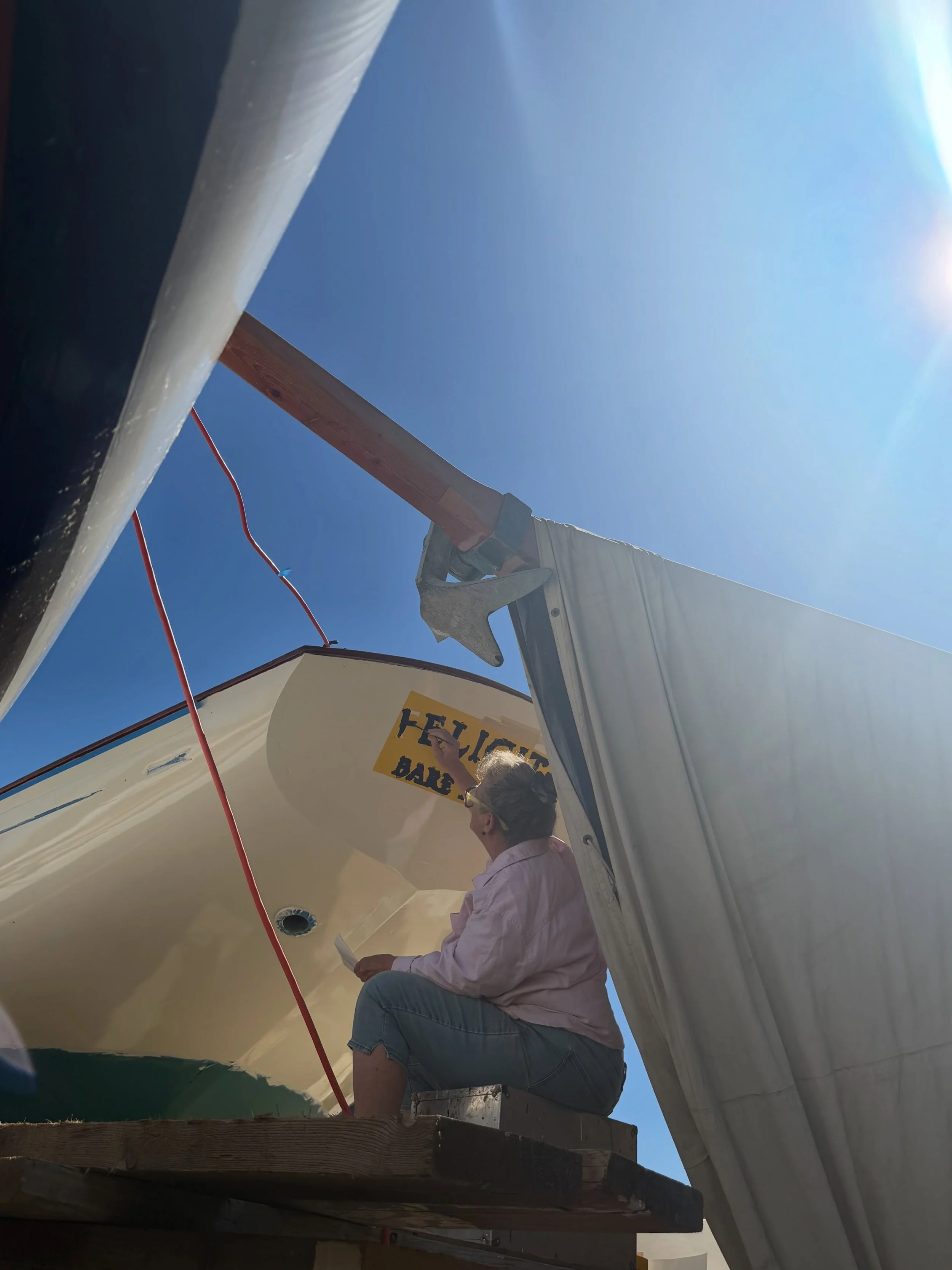 Spring commissioning is in full swing, and with it comes a familiar face on the waterfront. Each year, Melissa Patterson returns to lend her talent and craftsmanship to boats preparing for the season ahead. Her custom design work and hand painted boa