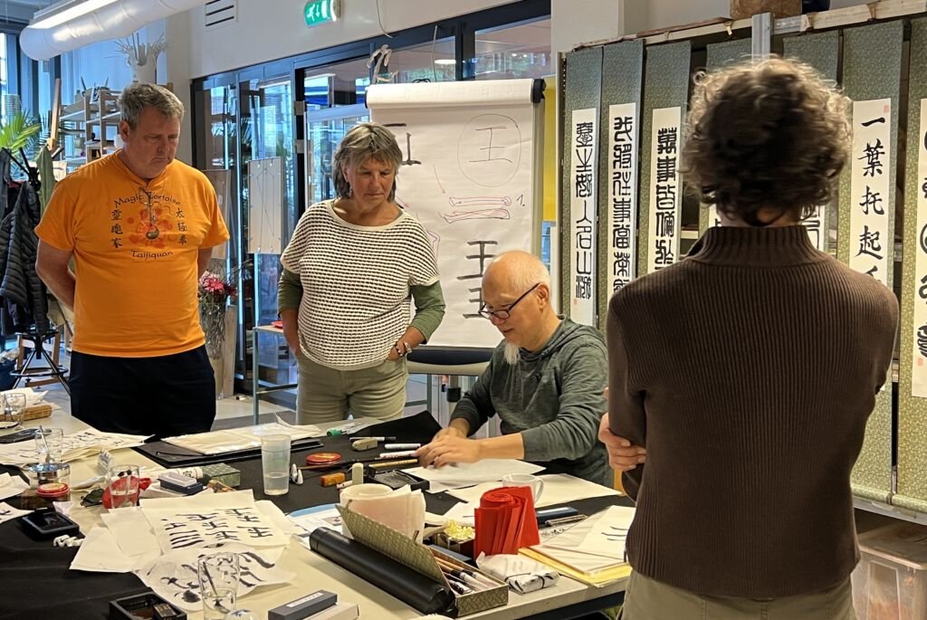 Ning demonstrating calligraphy to participants