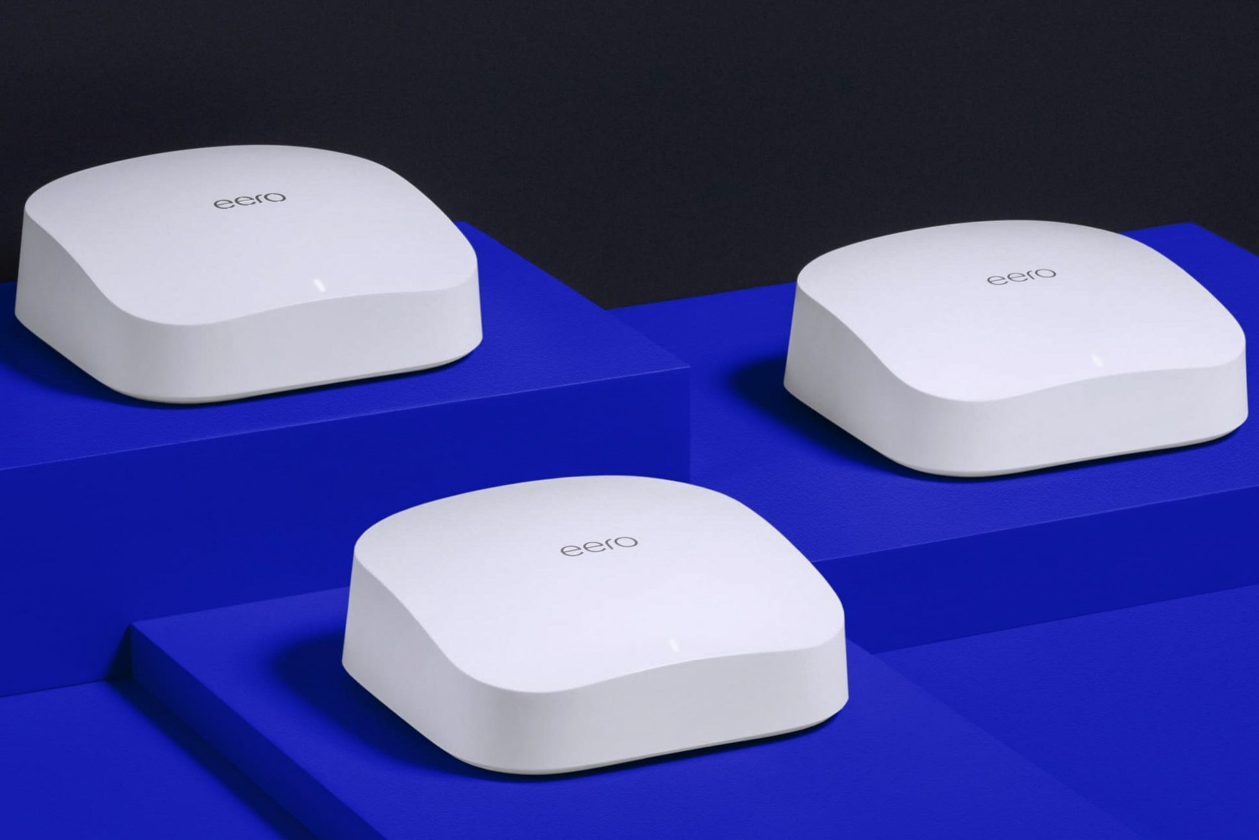 Three Eero mesh routers on blue stands