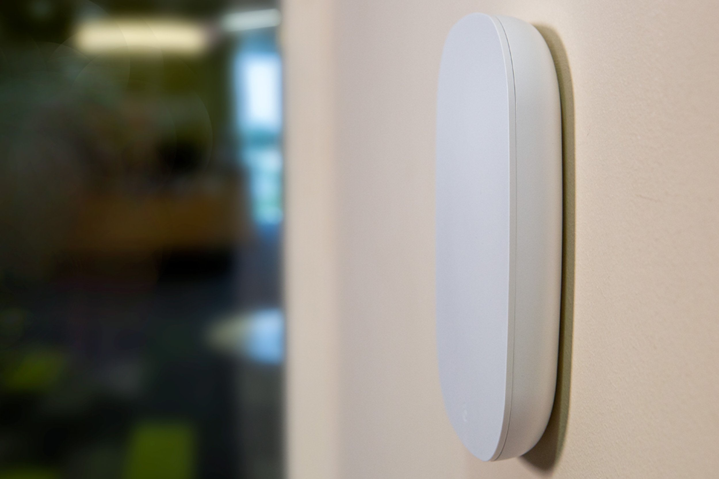 White Wireless Access Point mounted on a wall