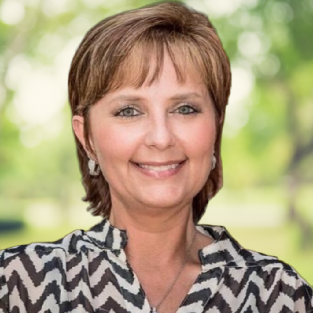 Smiling woman outdoors wearing a patterned blouse