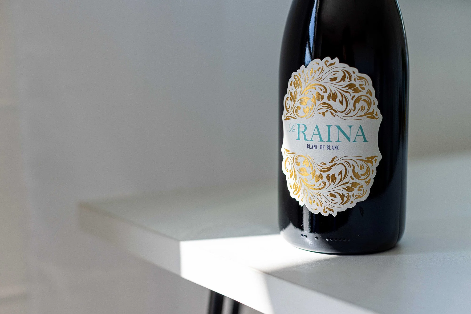 Blanc de Blanc bottle featuring gold foil label design by Via Visual
