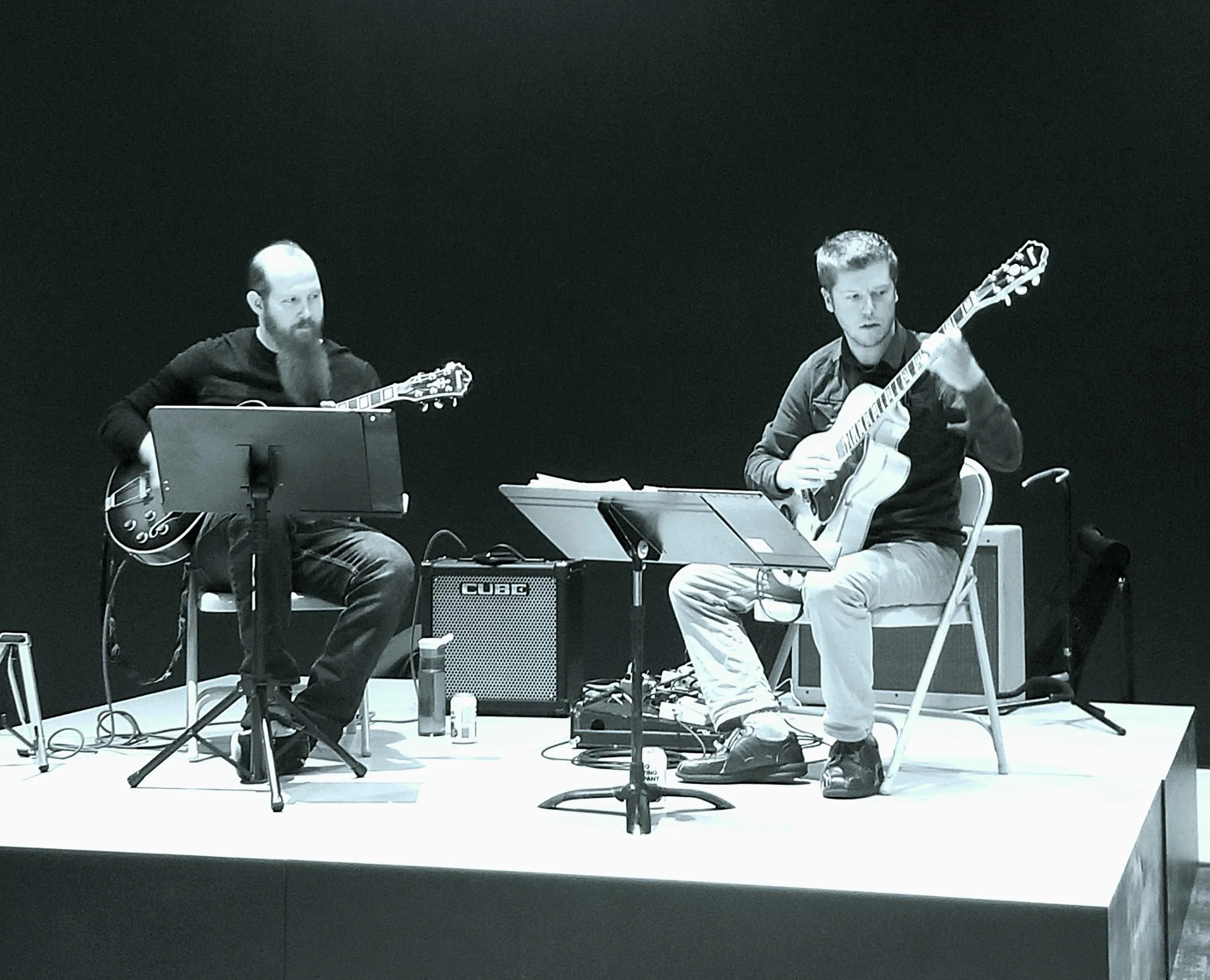 Two people playing jazz guitar