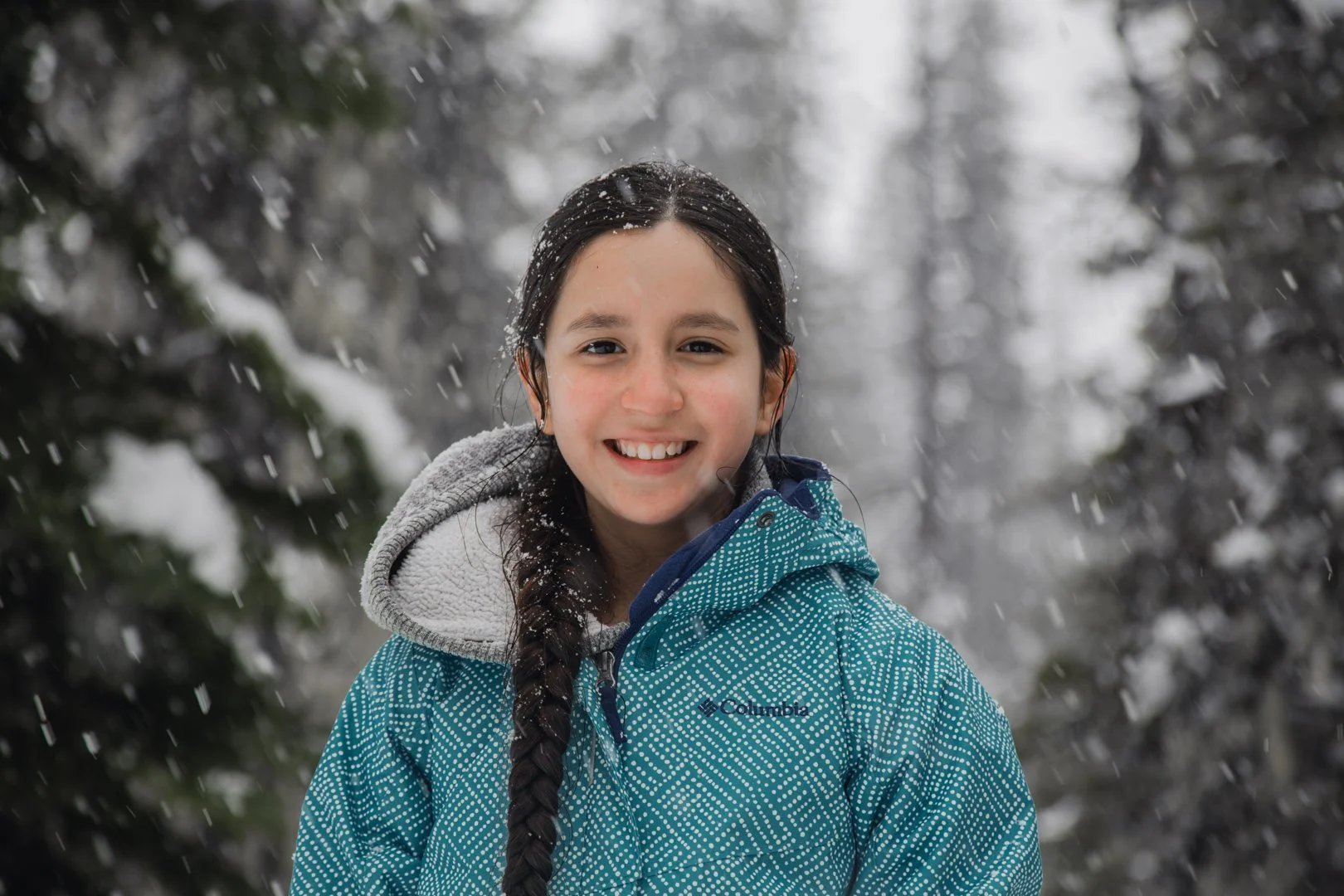 AWL-Year_End-Snowshoeing_Girl_Smiling_into_Camera.jpg