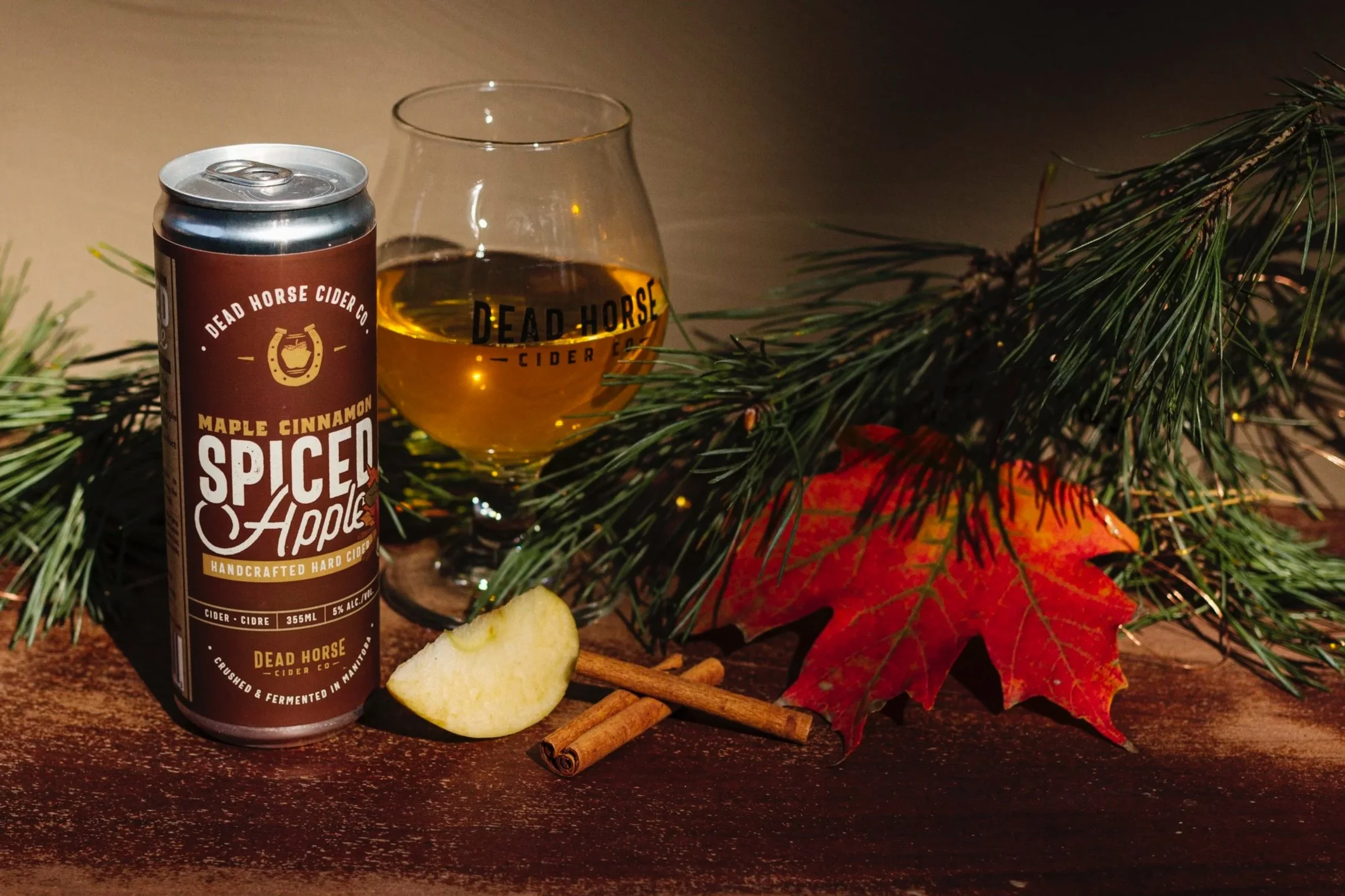 Display of canned beverages, cigar boxes, and baseball caps on wooden shelves in a retail store.