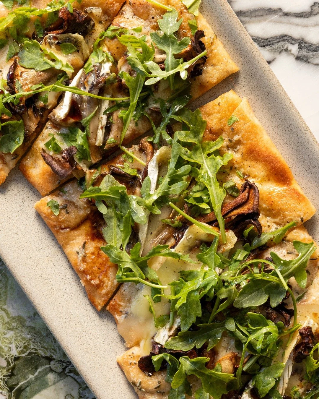 Rich, savory, and perfectly shareable,  our Mushroom Flatbread brings together roasted maitake mushrooms, caramelized onion cr&egrave;me fra&icirc;che, creamy brie, wild arugula, and a touch of saba. 

#high5iverooftop #uptownoakland #visitoakland #o