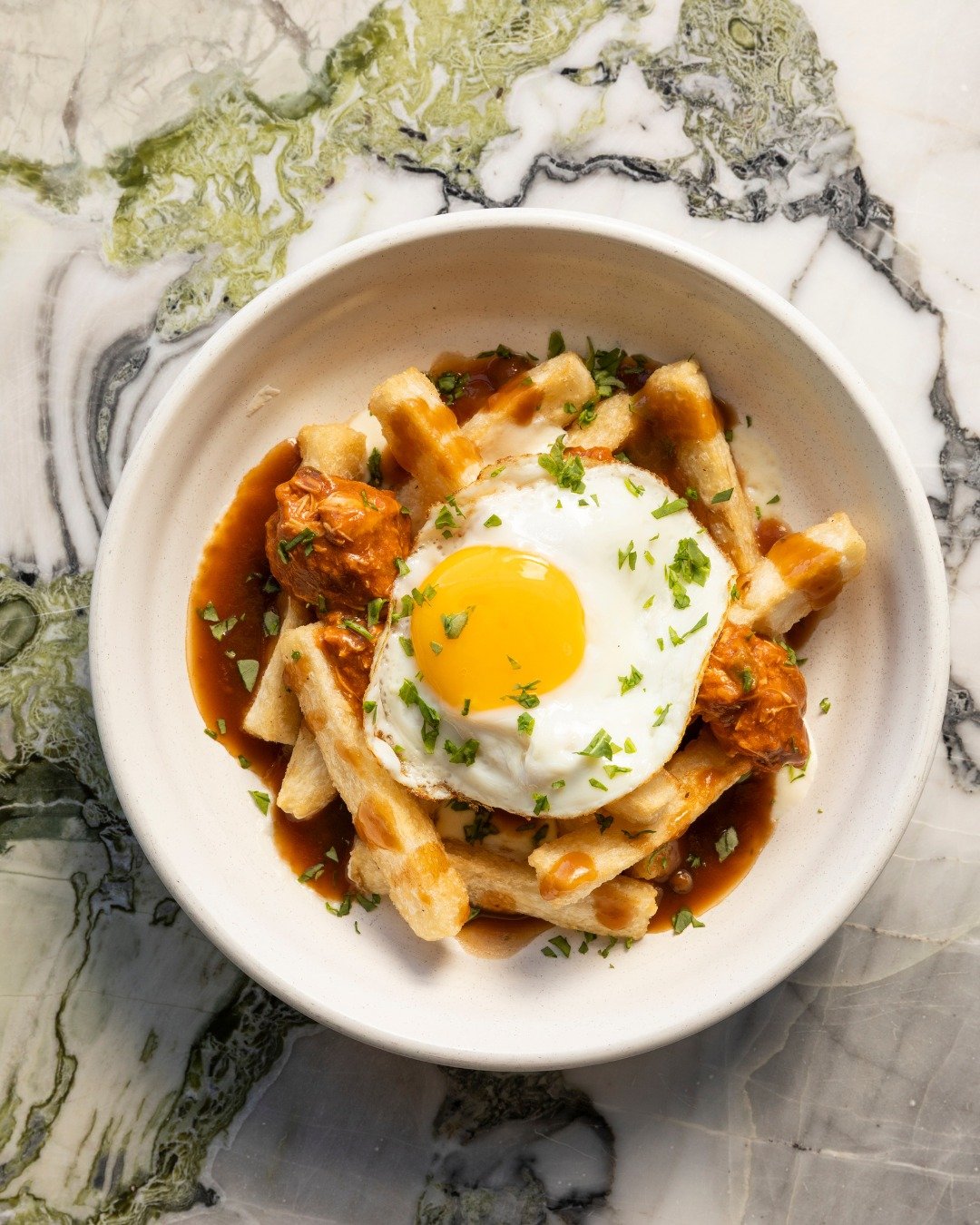 The bar bite you always say yes to. Our Yucca Poutine brings together braised short rib, rich beef gravy, cheese curds, crispy yucca fries, and a perfect fried egg. 🍳

#high5iverooftop #uptownoakland #visitoakland #oaklandeats #oaklandbars #sffood #